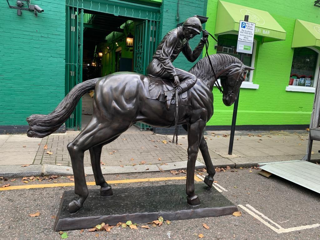 A superb large life-size bronze horse and jockey statue, 20th century. At over 9 feet tall - 2.7 meters I want to say it is actually bigger than life-size. This would make for a great centerpiece to a horse themed business or in a public space. The