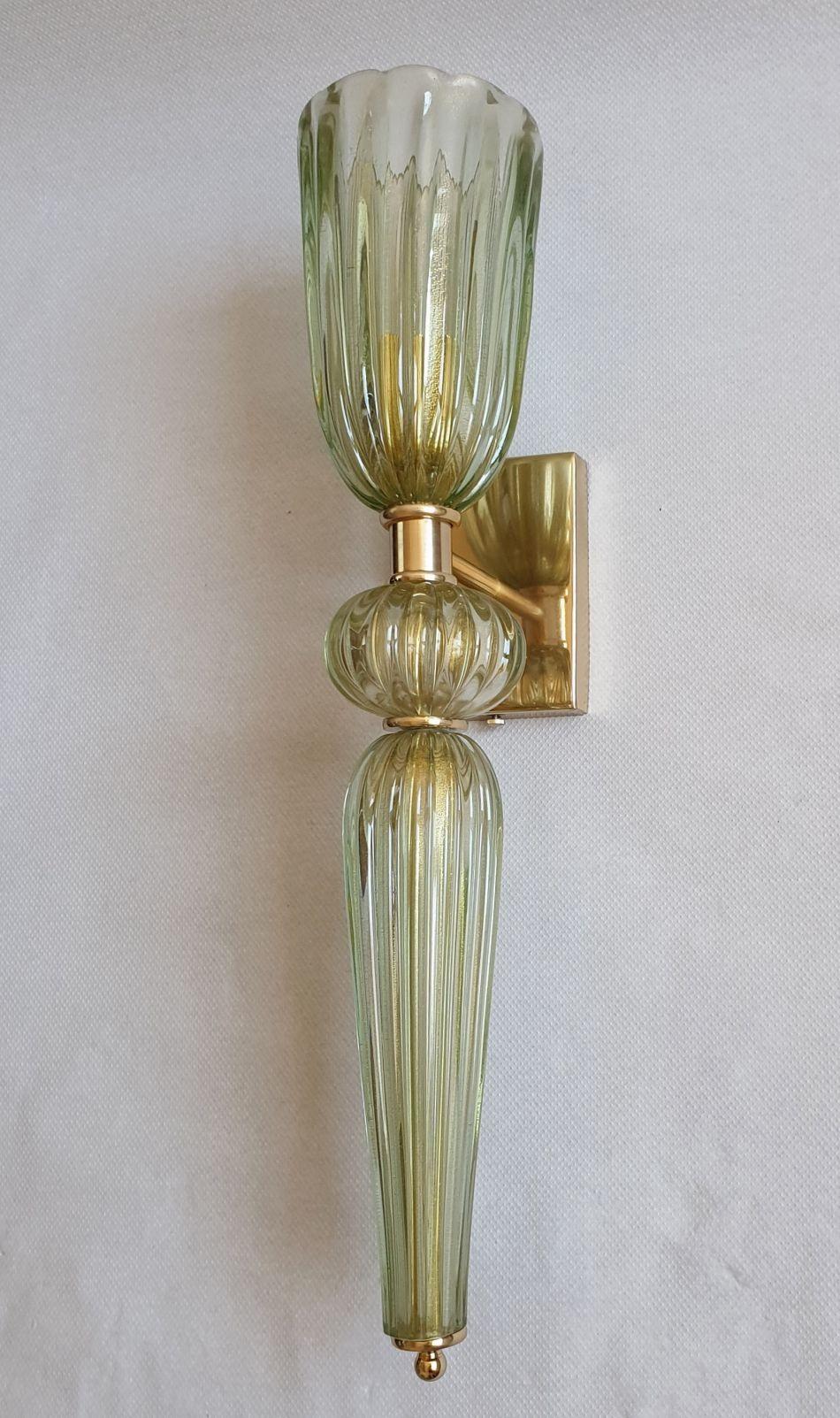 Two pairs of Mid-Century Modern large Murano glass wall sconces, attributed to Barovier, Italy 1970s.
Set of four sconces - Sold and priced by pair.
The torchiere style sconces are made of a hand-blown thick light green Murano glass, with real