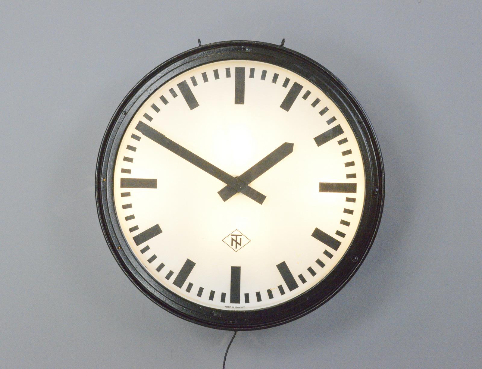 Large light up factory clock by TN, Circa 1950s

- Steel casing
- Glass face and dial
- Takes 3x E27 fitting bulbs
- New AA battery powered quartz motor
- Remote control switch for the lights
- Made by Tele Norma
- German ~ 1950s
- 72cm