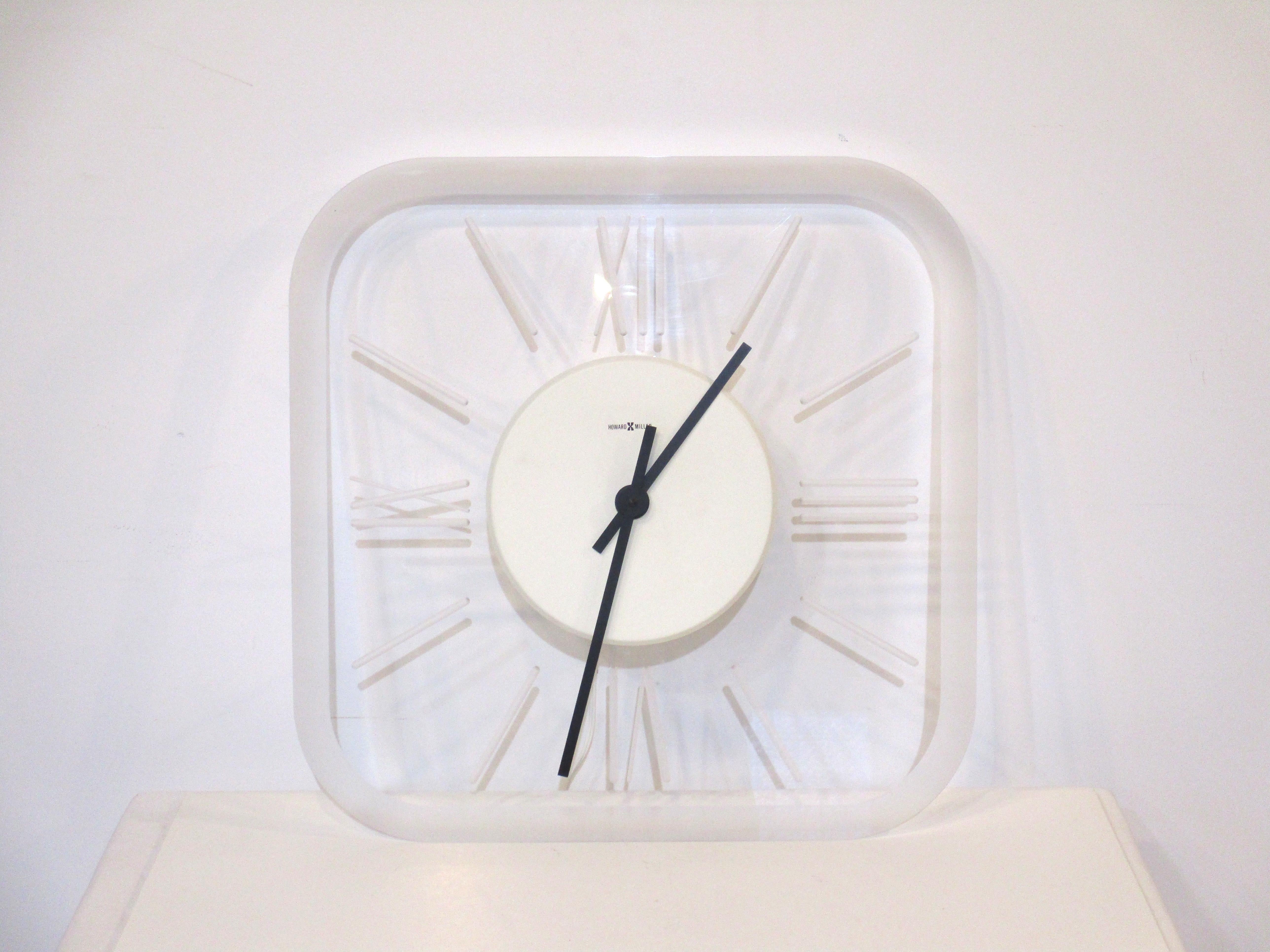 A large Lucite light up wall clock from a Michigan bank lobby with beveled edges and routed roman numerals to the back of the face. The center has a white metal fixture with the lighting element and black hands, the clock works has been replaced