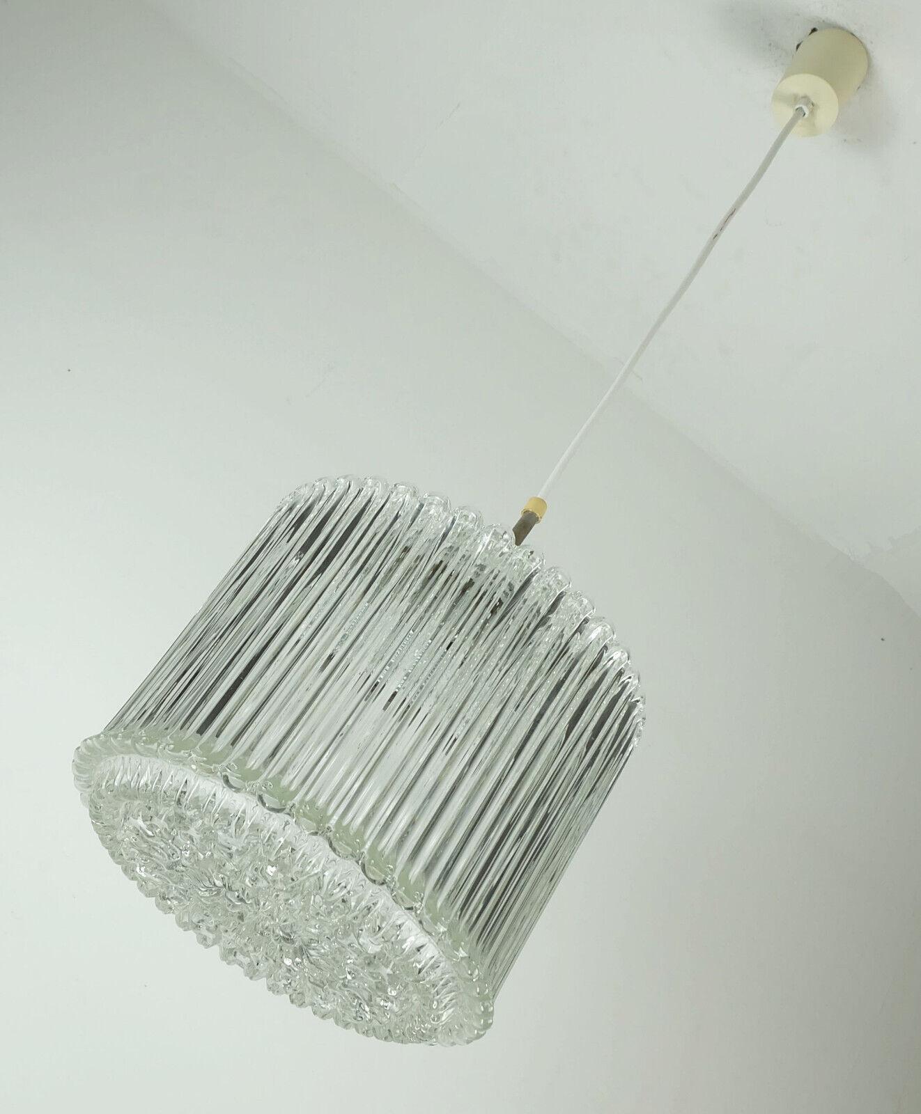 Amazing 1960s pendant light manufactured by Limburg, model no. P 911 a 1209. Heavy clear glass shade, with a ribbed surface structure on the outside, with a “bubble” surface at the top and bottom. Chrome plated metal bracket. White electric wire and