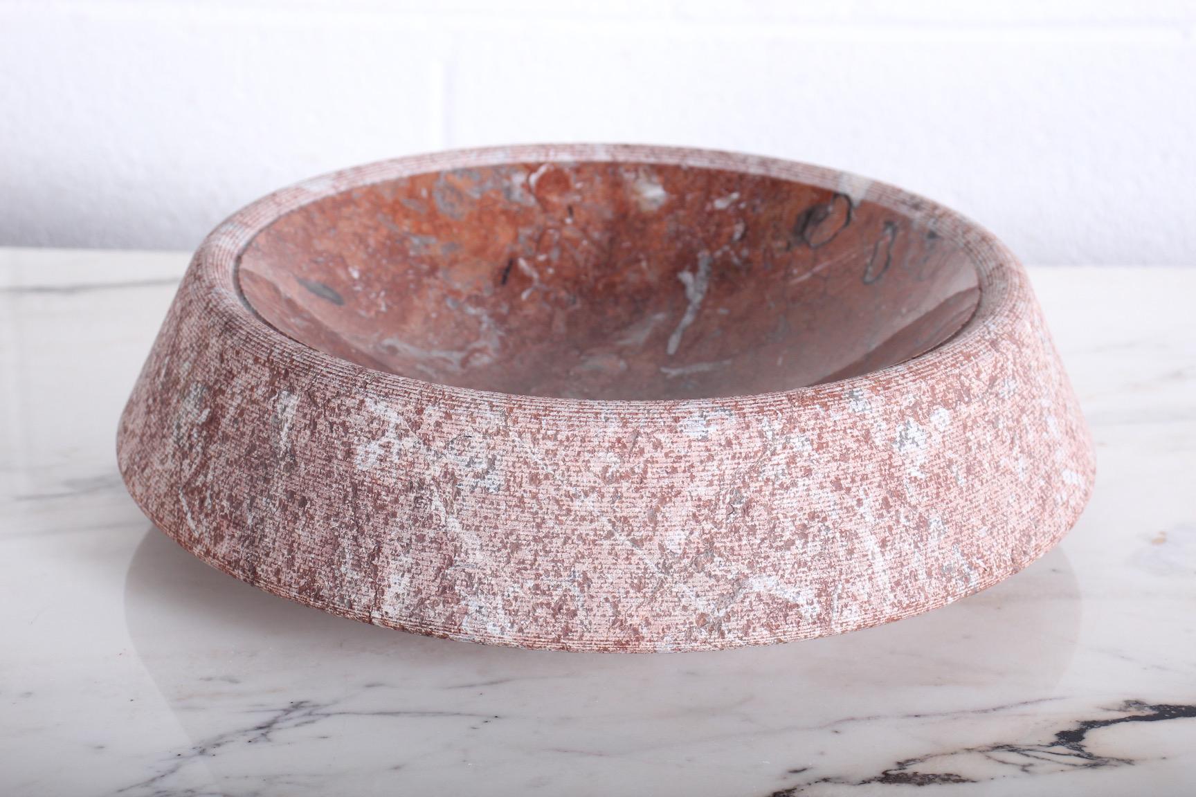 A large centerpiece designed by Giancarlo Cacciatori for Up & Up. Red bilbao limestone bowl with incised sides and polished interior.