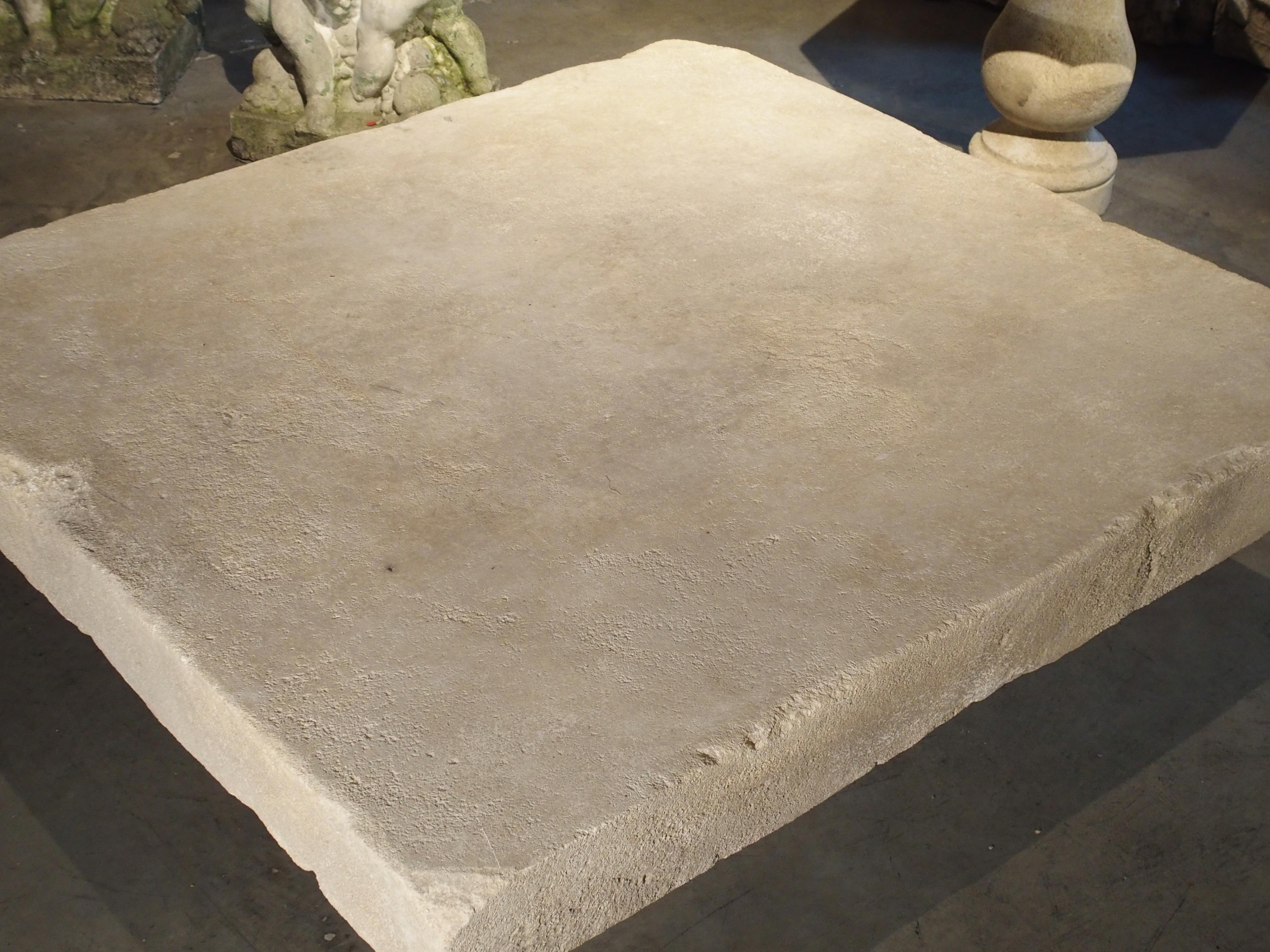 This versatile coffee table from the South of France has been carved from the famous Estaillade stone of Provence. The top slab is made from one thick piece of limestone, and the base also made from one big block. This table can be used with any