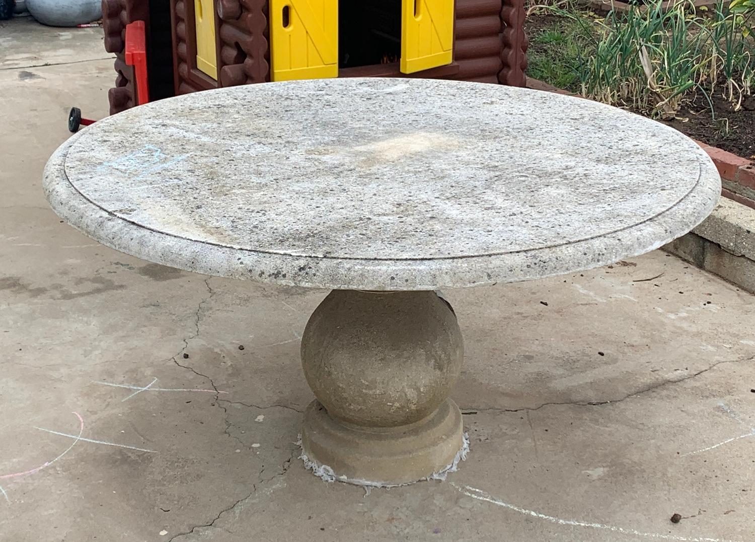 Stunning dining table is solid limestone by Treillage LTD.This table is very substantial, can be used indoor or outdoors, the table top has a knife edge design and is around 3-400 pounds The pedestal has a beautiful design and the top sits right on