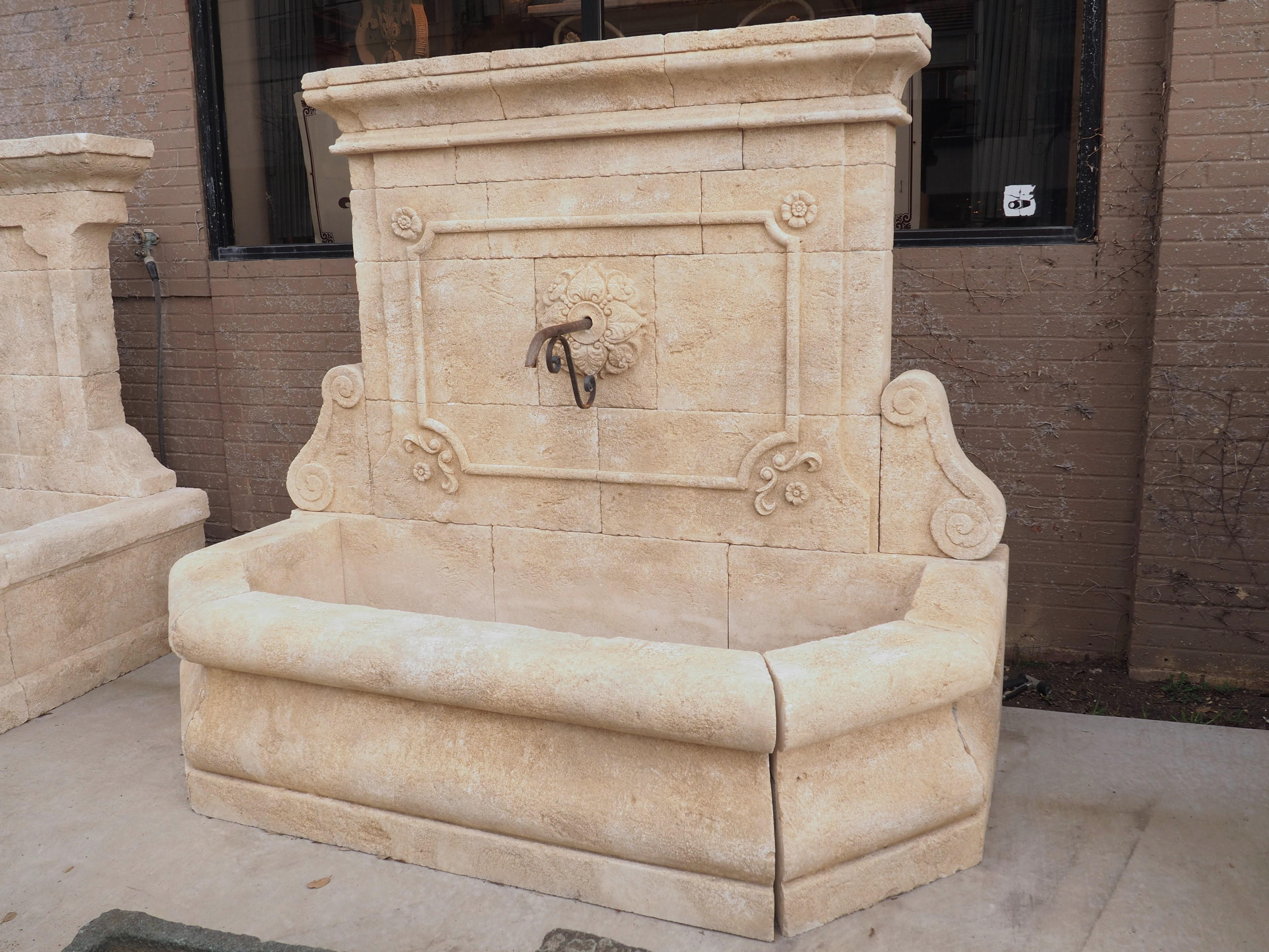 Hand carved in Vaucluse (Southeastern France), this majestic wall fountain is comprised of 22 pieces of Estaillade limestone. 16 Stones comprise the back wall, including the crown (three stones) and the volute scrolls at the base (two stones). Thick