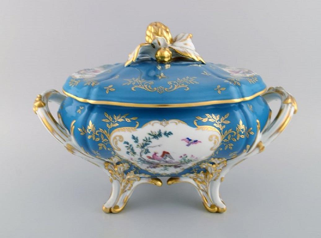Large Limoges lidded tureen with hand-painted birds in landscape and gold decoration. 
Classic tureen in Sevres style. Dated 1960.
Measures: 37 x 25.5 x 23.5 cm.
In excellent condition. Small chip on one foot.
Stamped.
