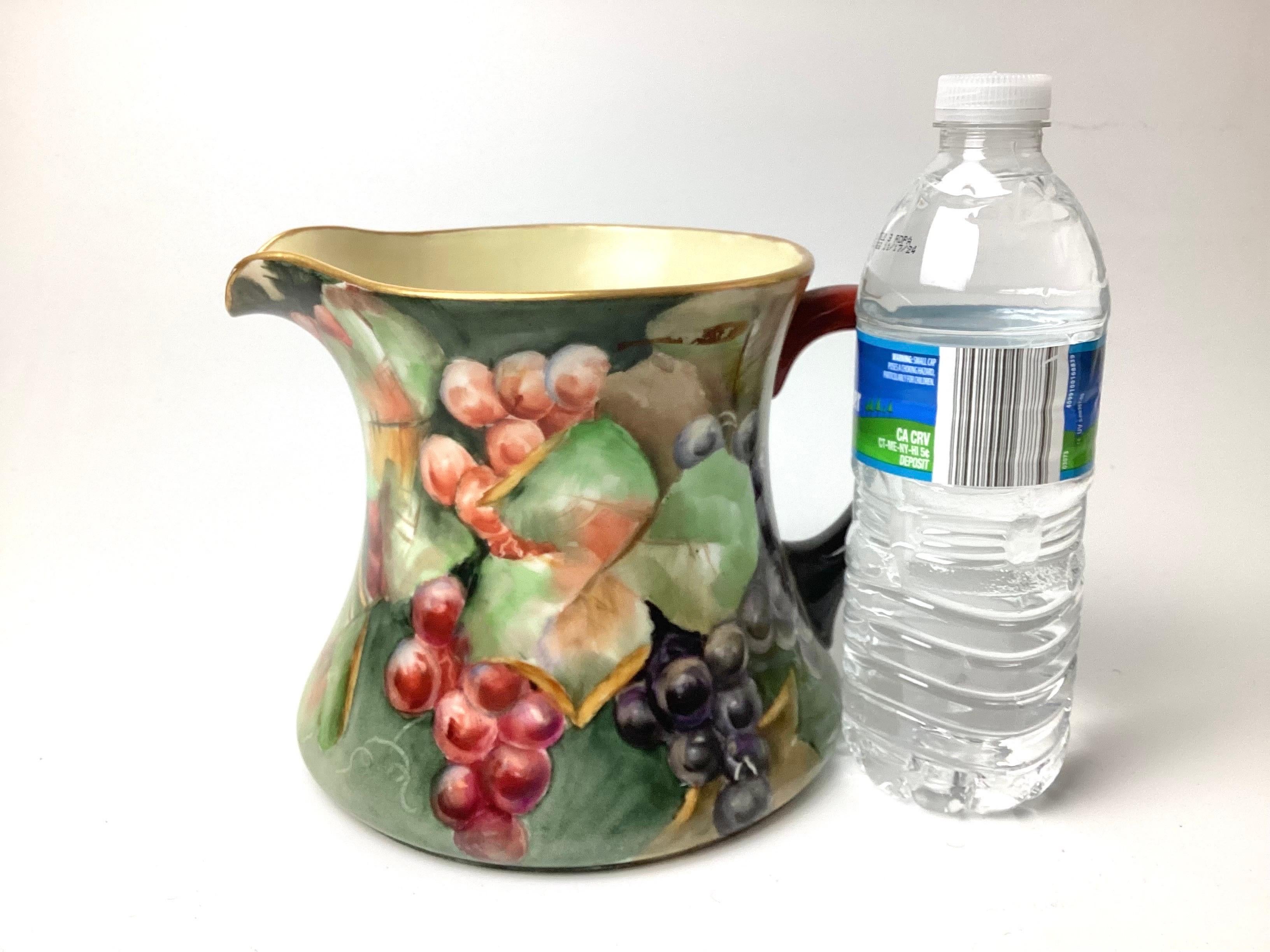 Large Limoges water pitcher hand painted with grapes. Grapes wrap all around the pitcher. Signed with a mark and letters on the bottom along with the Limoges France marking. Wonderfull condition.