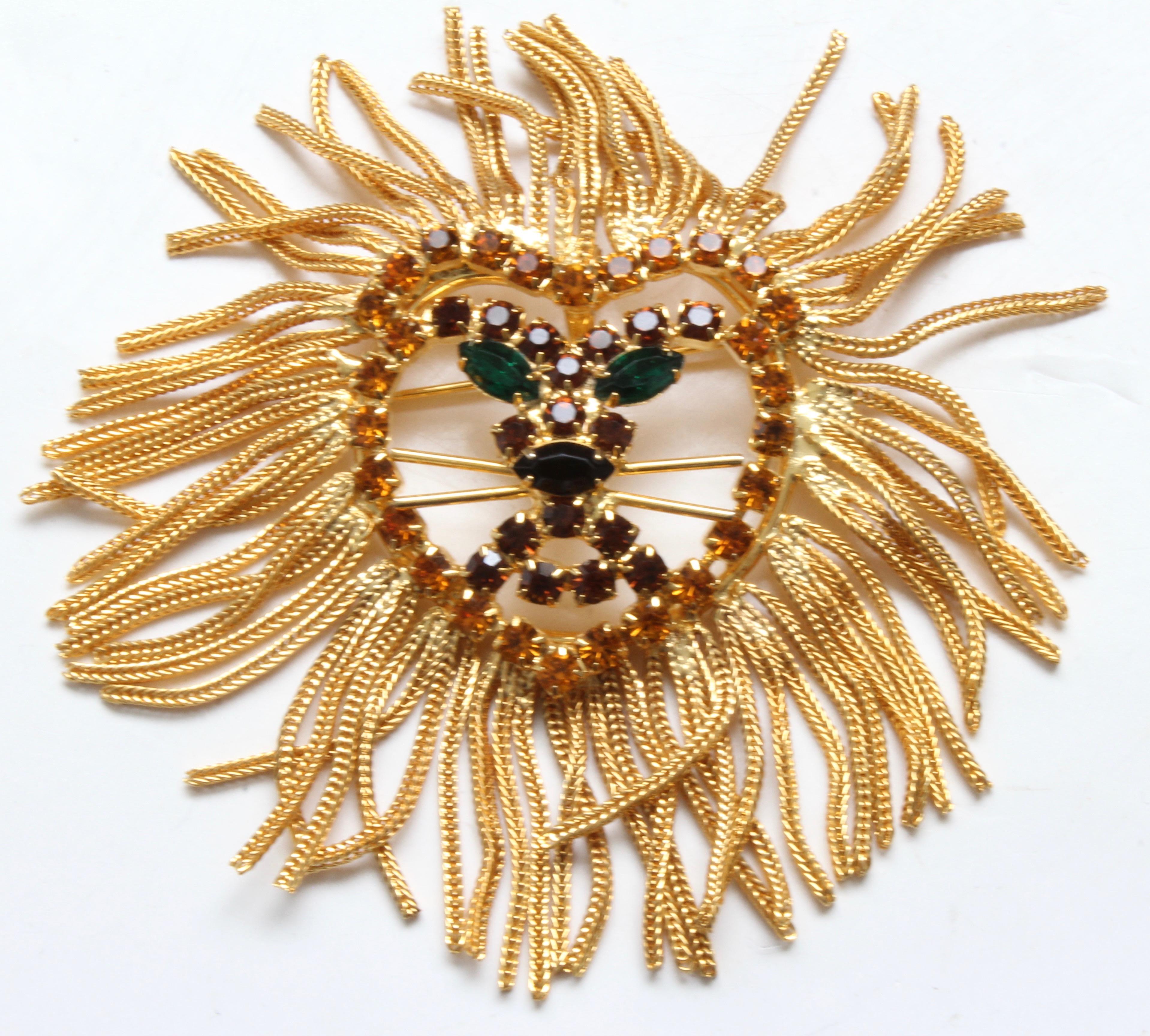 This fabulous large lion head features colored rhinestones and a shaggy chain fringe mane, created in the style of Dominique, aka Dominic De Tora, who also designed costume pieces for Weiss and Eisenberg.  This figural piece can be worn as a brooch