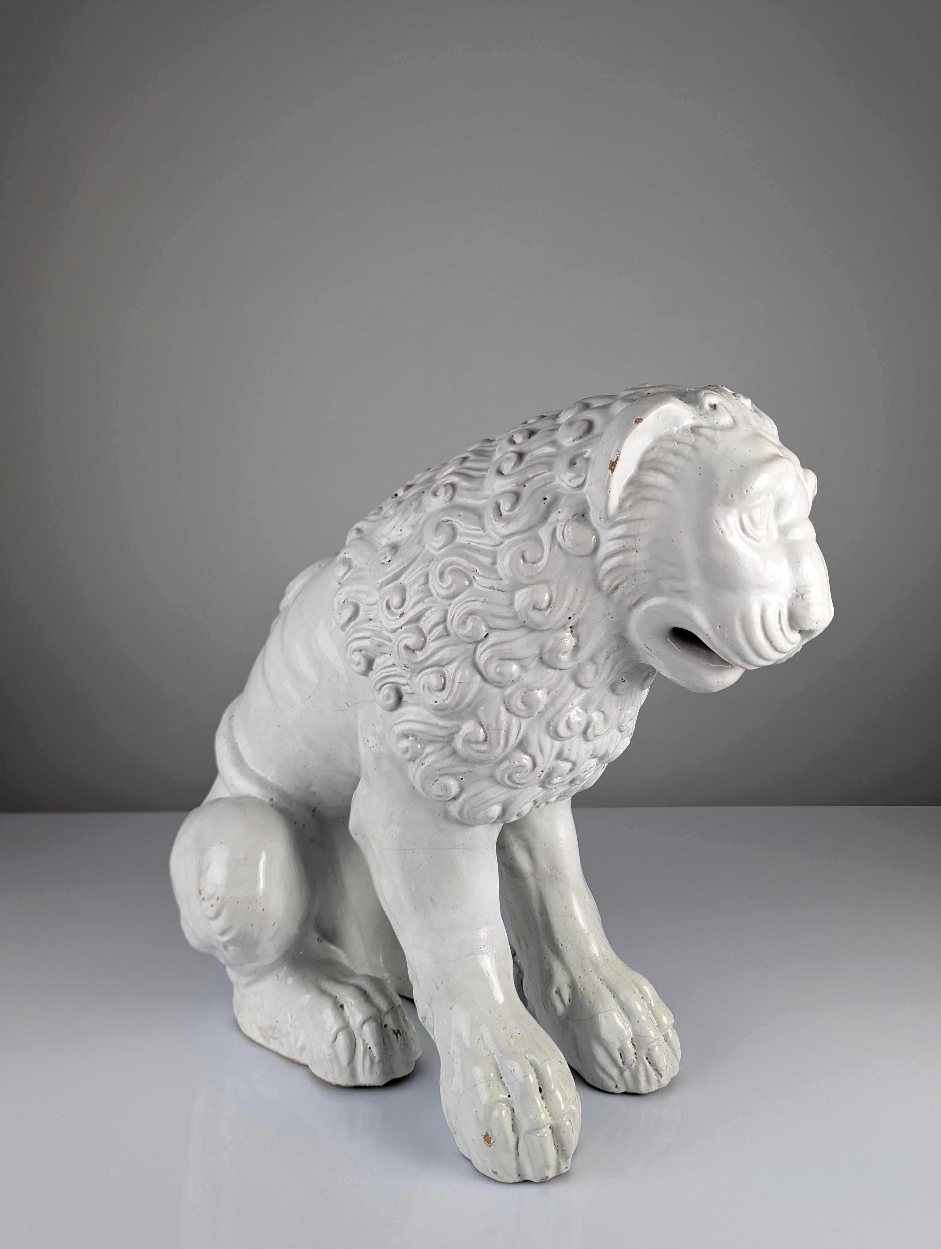 Majestic large lion sculpture in white glazed earthenware, crafted in the early 20th century and reflecting an exquisite Romanesque style. This piece captures the essence of Romanesque art with its robust forms and meticulously sculpted details,