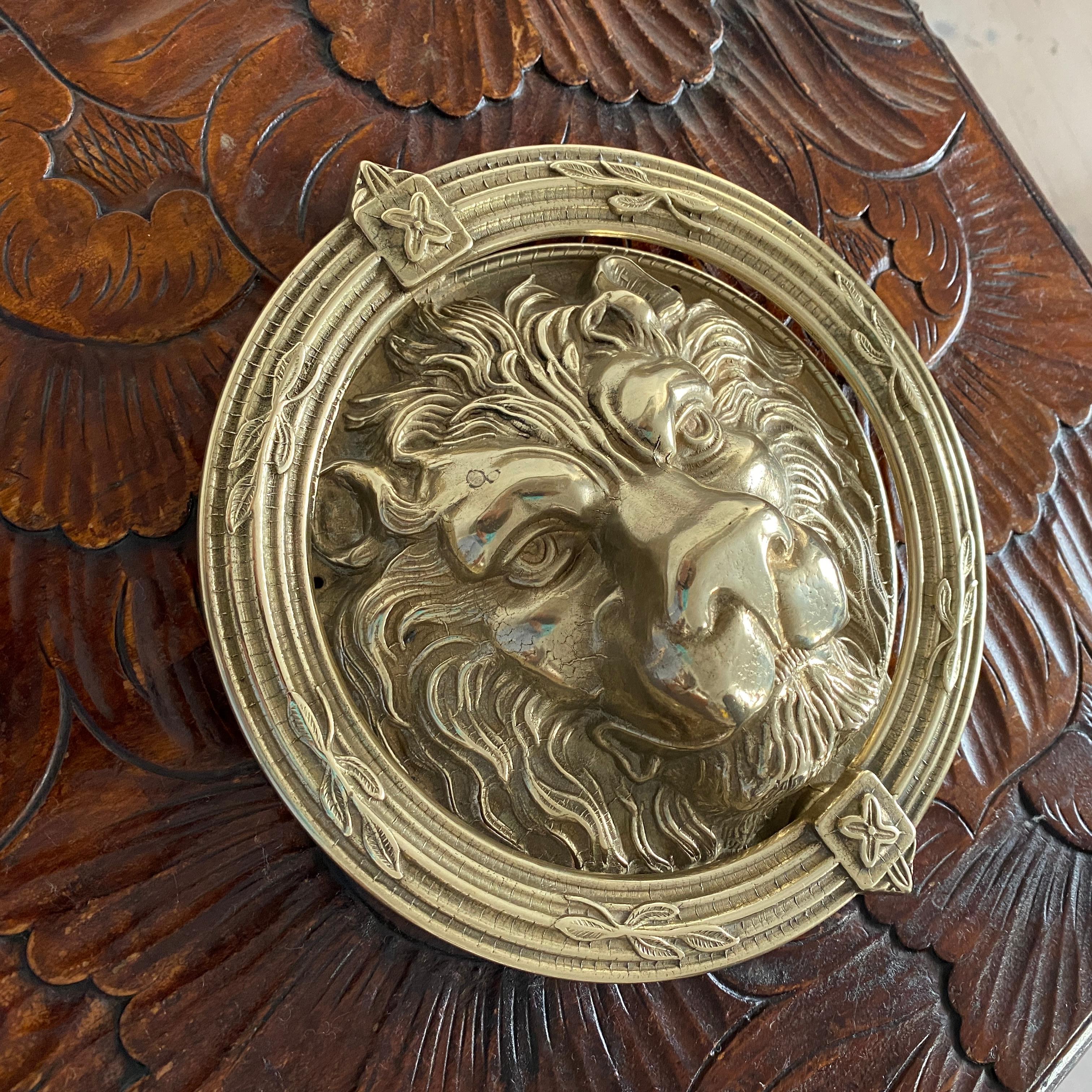 A very large and heavy English brass door knocker in the shape of a Lion's head. 