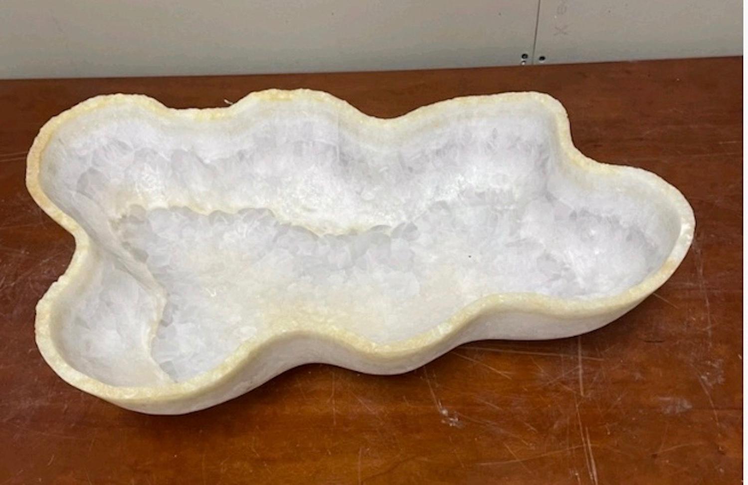 A large hand carved white and ivory live edge onyx bowl or centerpiece in an impressive size is comprised of white semi-opaque and clear quartz with bands of ivory. This utilitarian and stunning centerpiece makes a beautiful addition to any space
