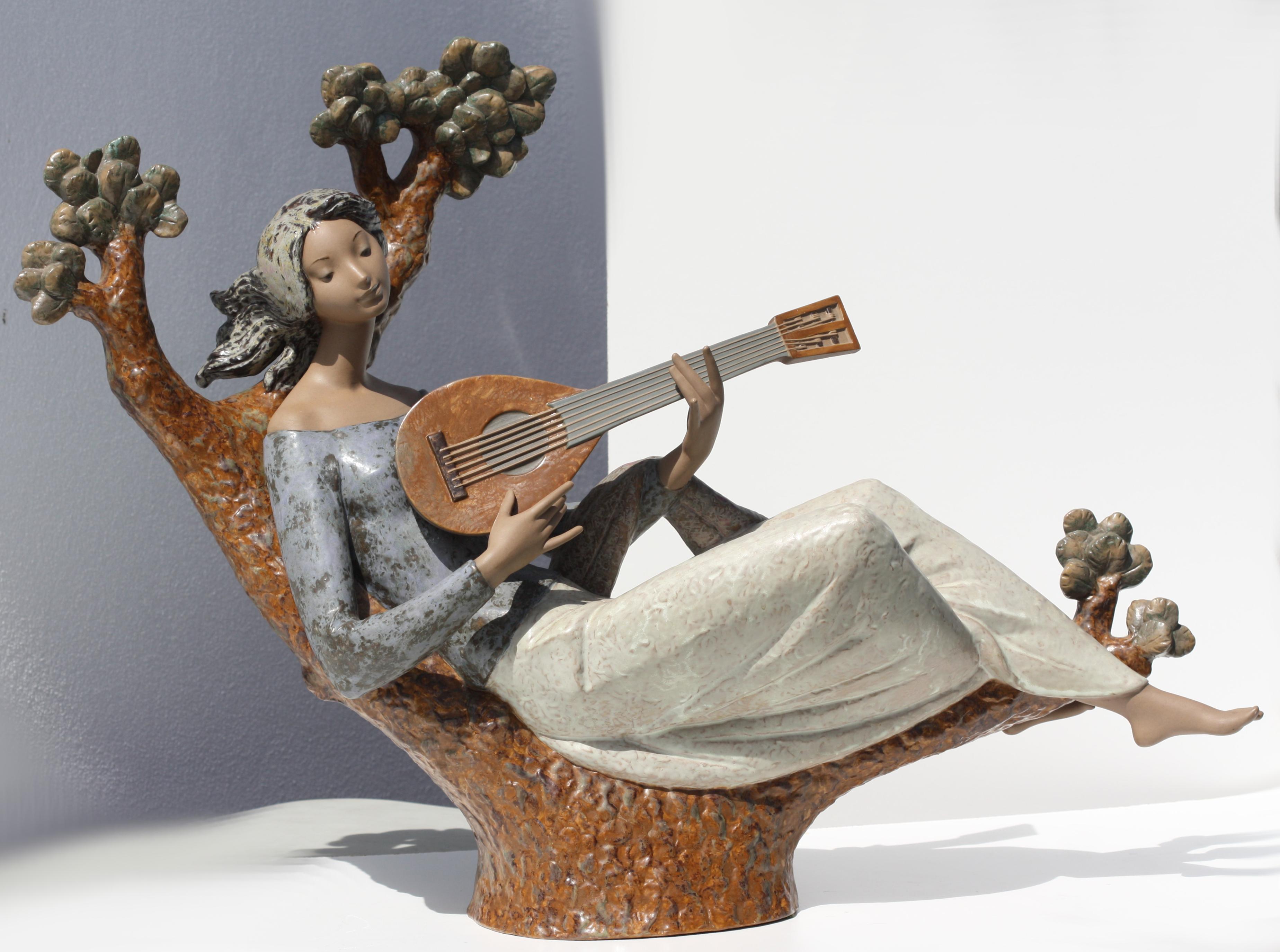 
Large Lladro Figure of a Girl Playing a Mandolin
circa 1970,the underside marked with the artists Antonio Ruiz and with painters signature, no. 257, of an edition 750. the figure recumbent on a pine tree with mandolin, mat finish. (one finger on