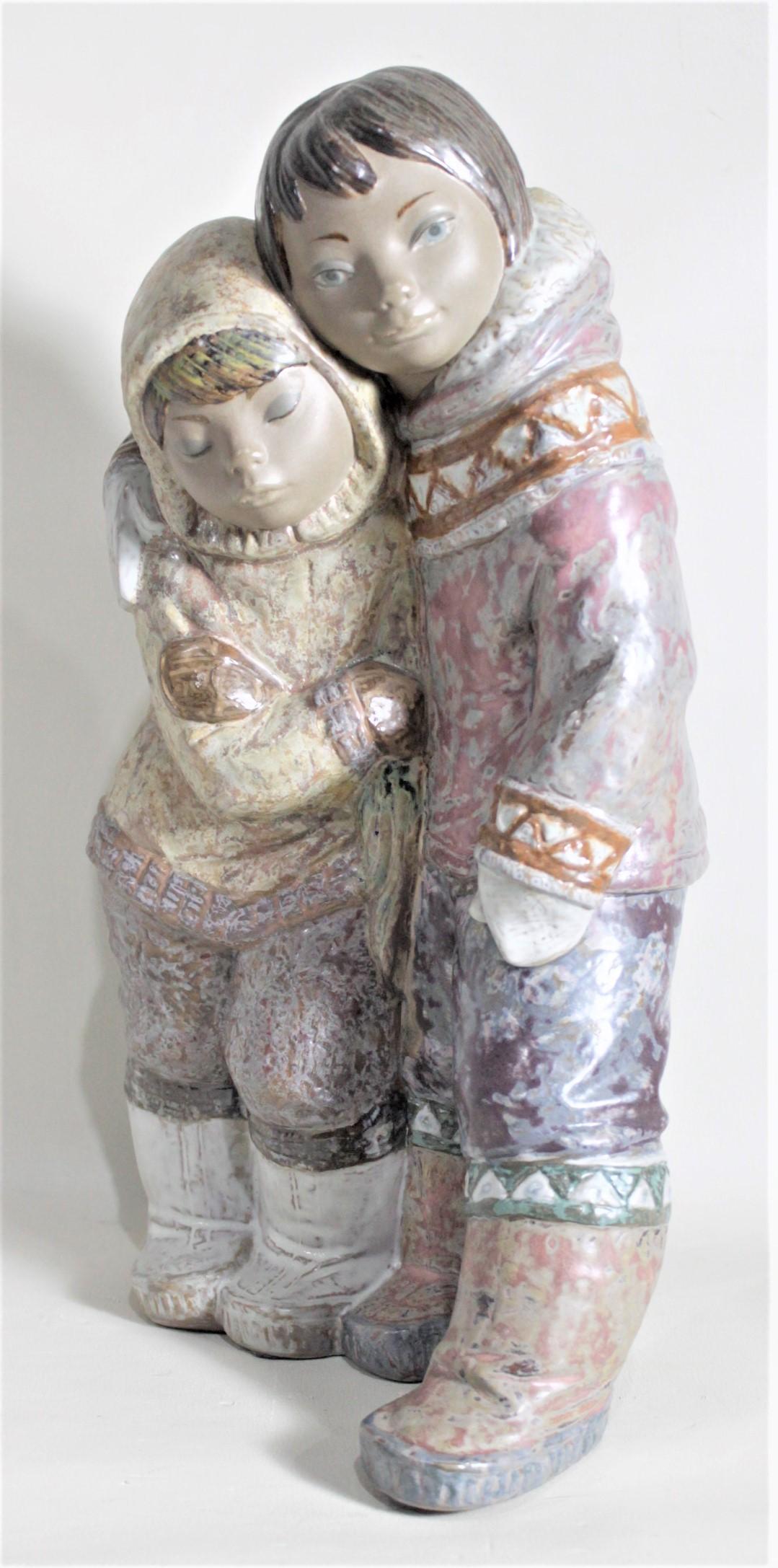 Spanish Large Lladro Yupik or Inuit Boy and Girl Affectionately Embracing Figurine For Sale