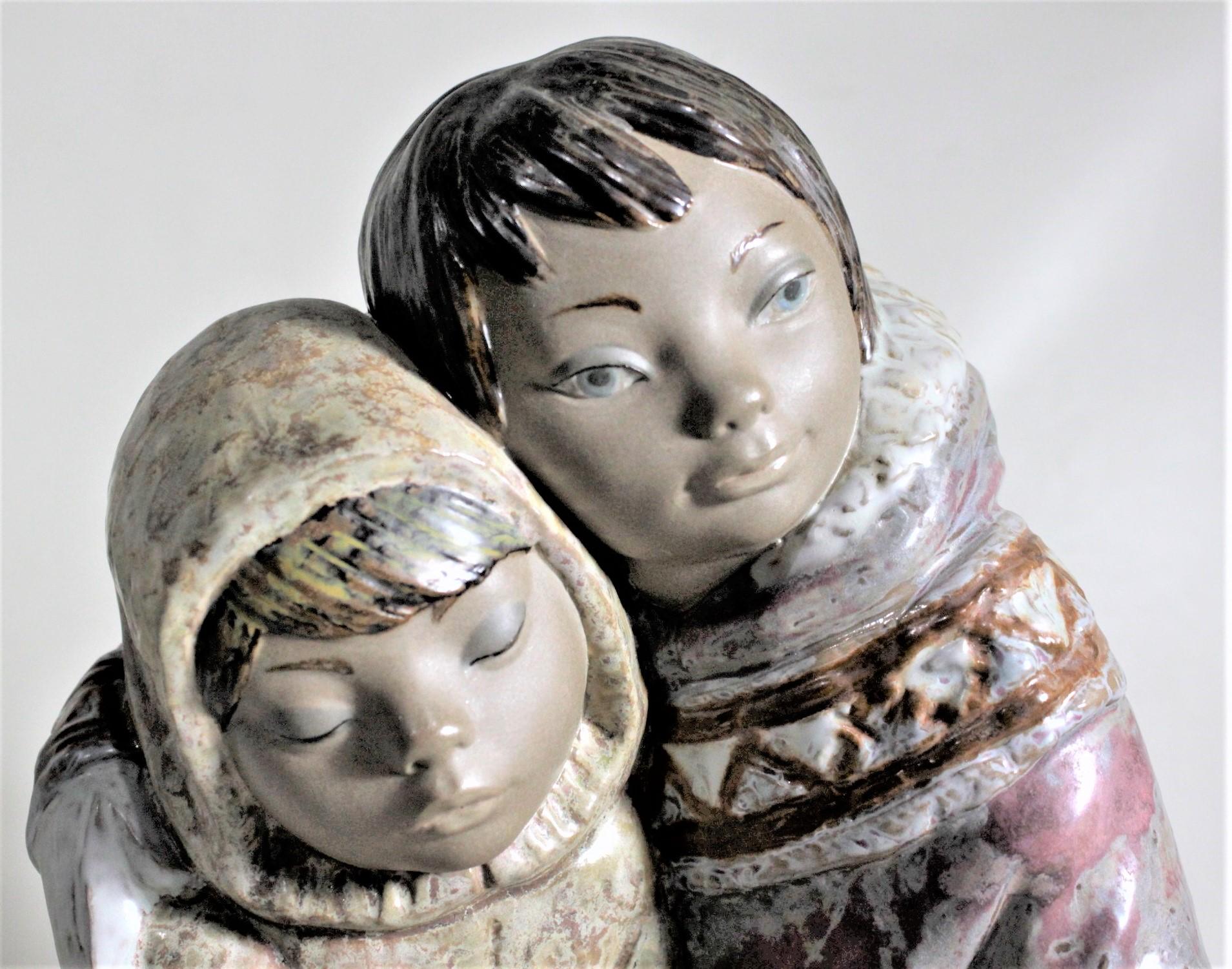 Hand-Painted Large Lladro Yupik or Inuit Boy and Girl Affectionately Embracing Figurine For Sale