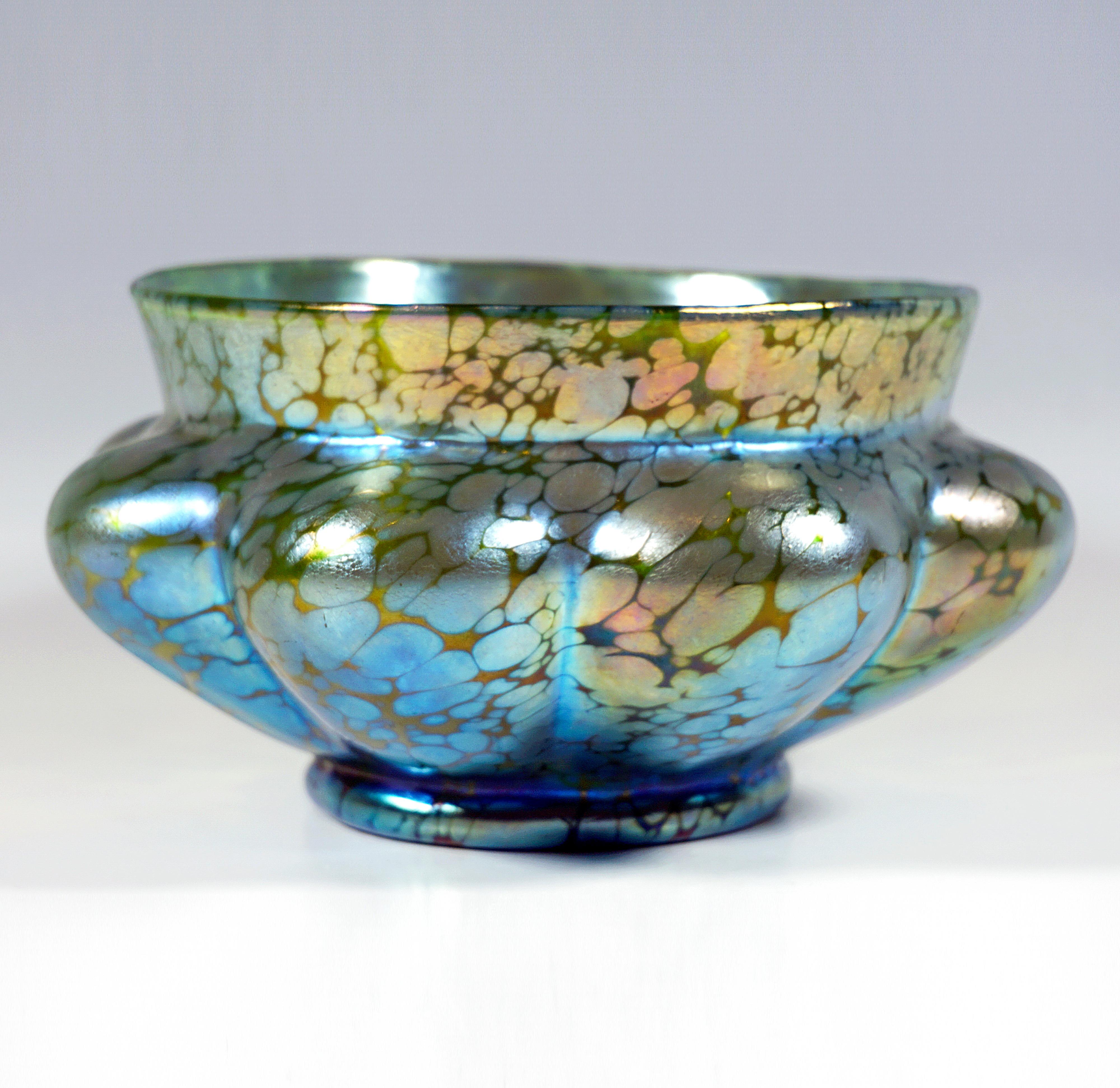 Finest Bohemian Art Nouveau Glass Item:
Mould blown, wide bowl on a stand ring, eightfold ribbed, outwardly curved wall with humped protuberances, tamed by a smooth, slightly outwardly turned mouth rim, ground and polished pontil on the
