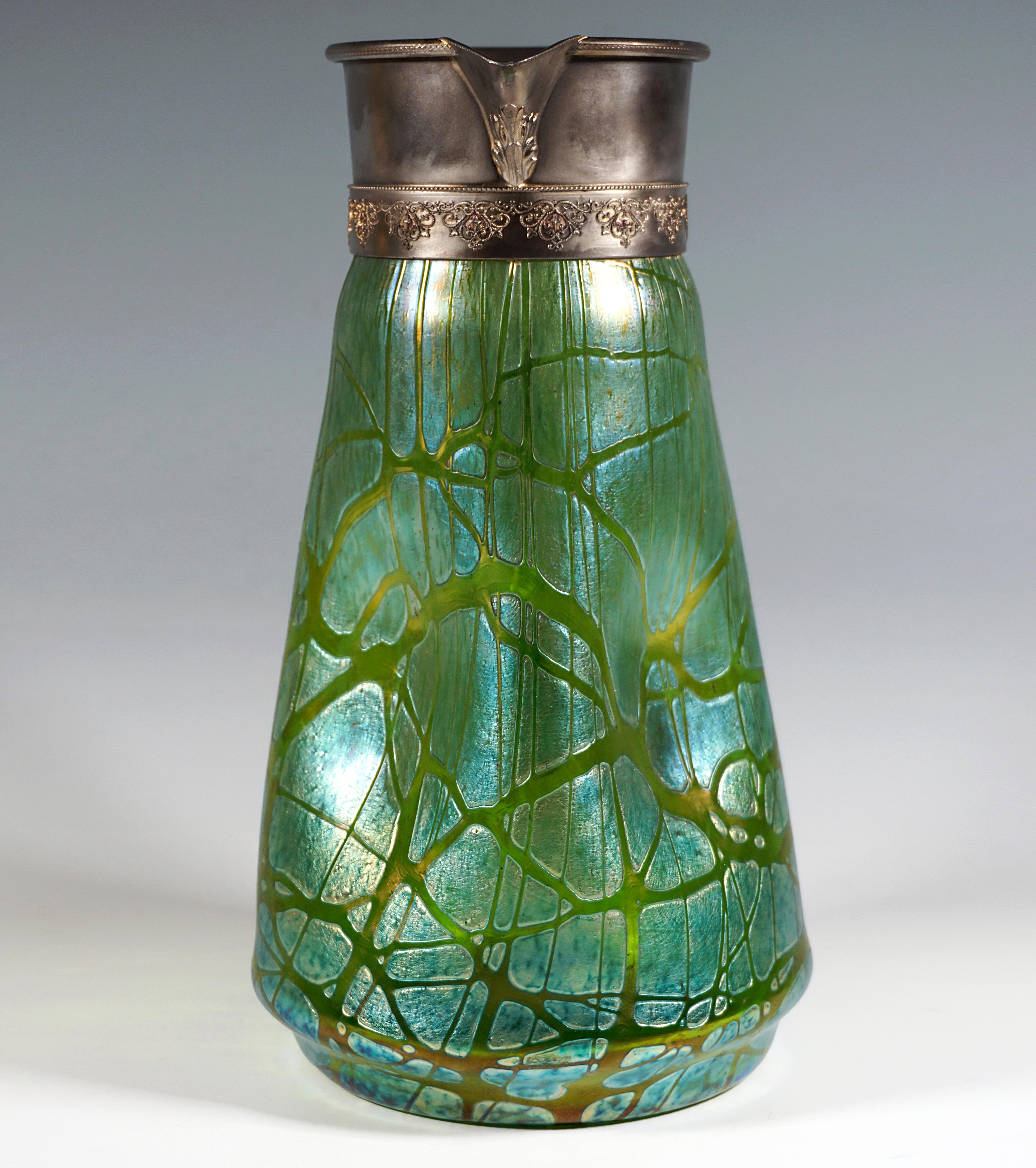 Exceptional Bohemian Art Nouveau Glass Jug:
Mould-blown, conical glass vessel on a recessed, flush stand, the wall moulded in four places, applied handle, wide opening with high original pewter mount with relief decoration and spout.

Shape: Pattern
