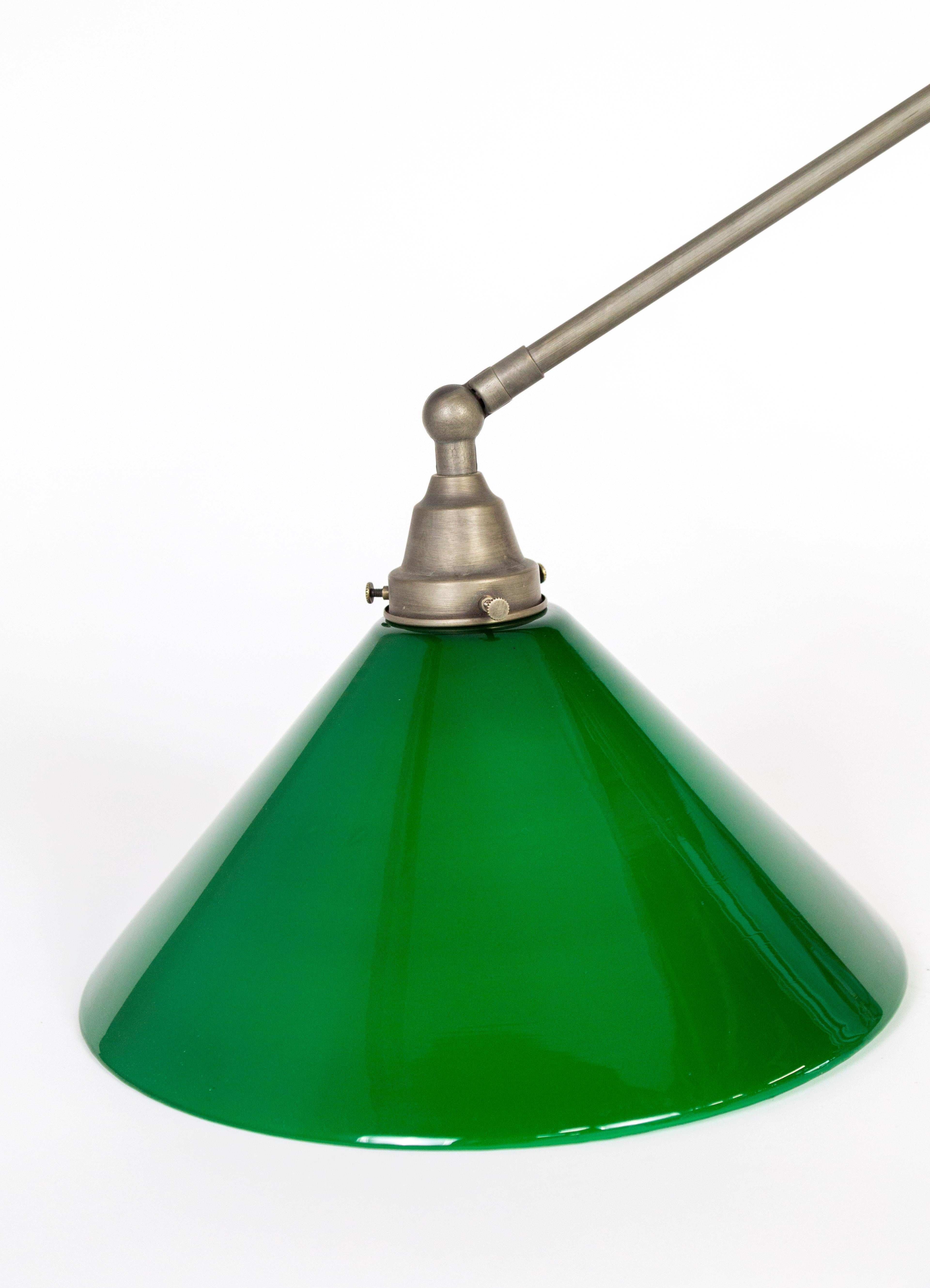 A large, antique, cone shaped, green glass shade has been newly configured as a swing arm wall lamp. Adjustable arm with antiqued nickel finish. American, circa 1930s. We have 2 available, price listed is for one lamp. Glass diameter: 14
