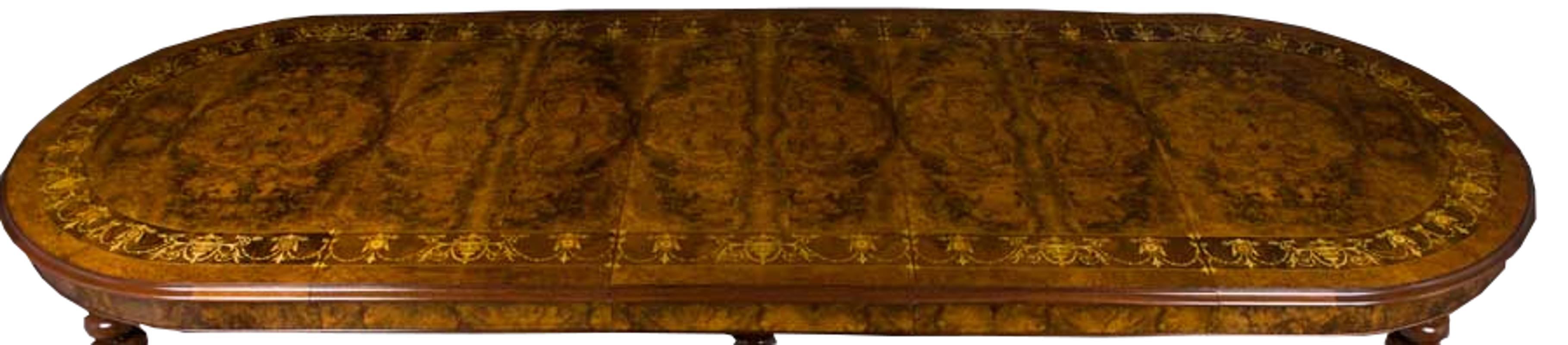 This truly top of the line large oval marquetry crank dining table provides elegance and quality in spades. Stunning burled walnut comes inlaid with rosewood, satinwood, and elm in various shapes such as urns and garlands. Also, the finish is a true