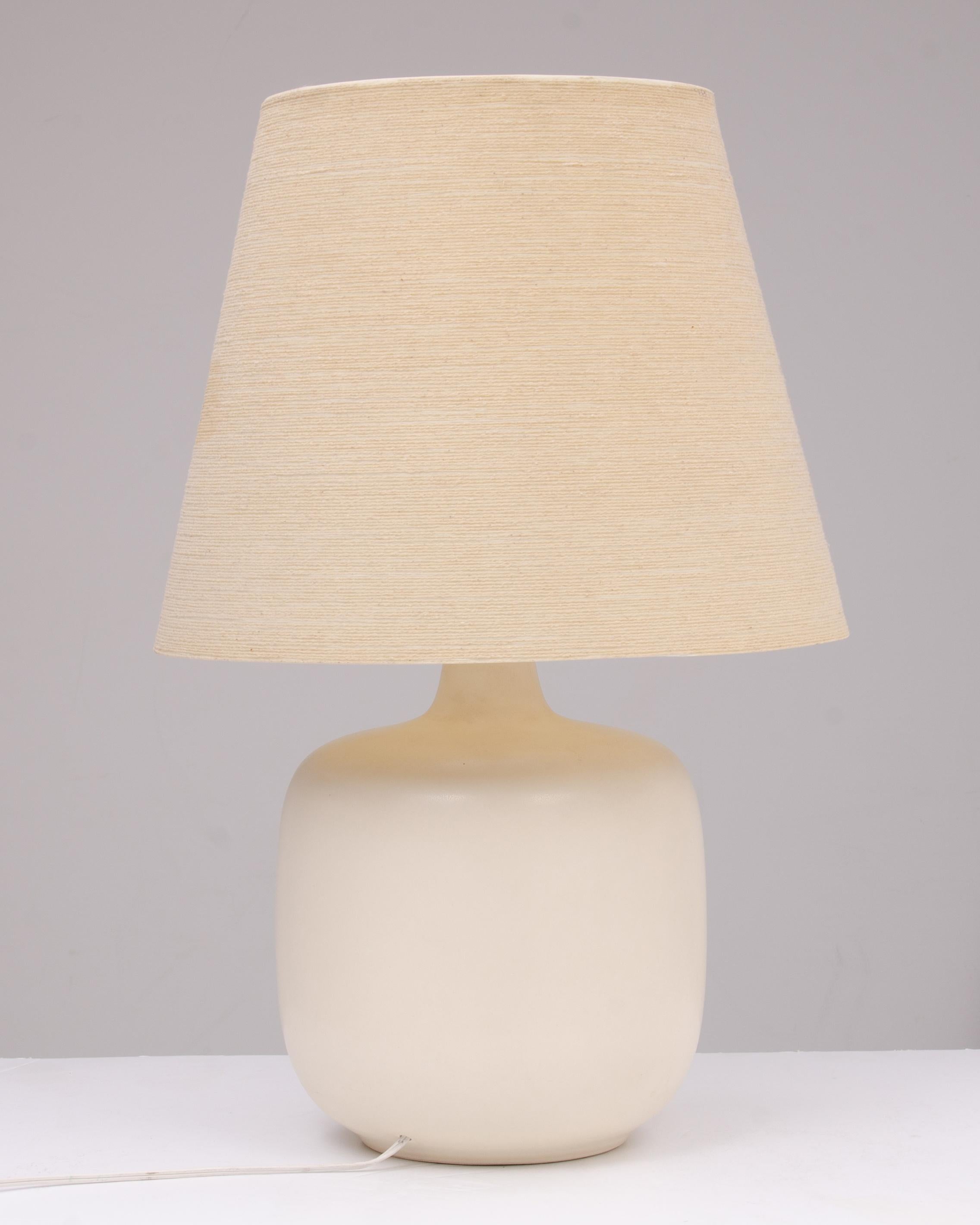 An impressive and large Lotte & Gunnar Bostlund table lamp in bone off white with the hard to find original shade in very good condition. At some time in the past the socket was been replaced, so the lamp is unmarked.The lamp has a 10” diameter, the