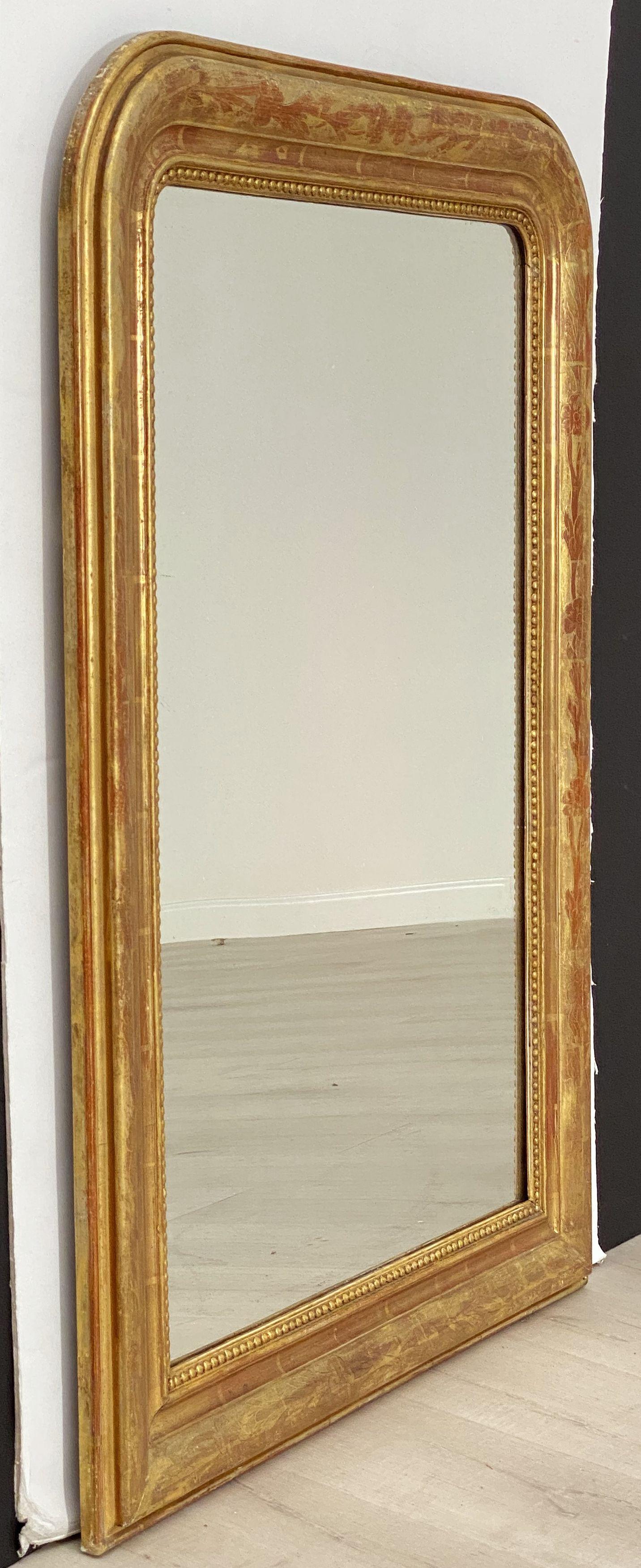 A handsome large Louis Philippe gilt wall mirror from France, featuring a lovely moulded surround and an etched foliate design showing through gold-leaf.

Dimensions: H 38 3/4 inches x W 28 inches

Other sizes available in this style.