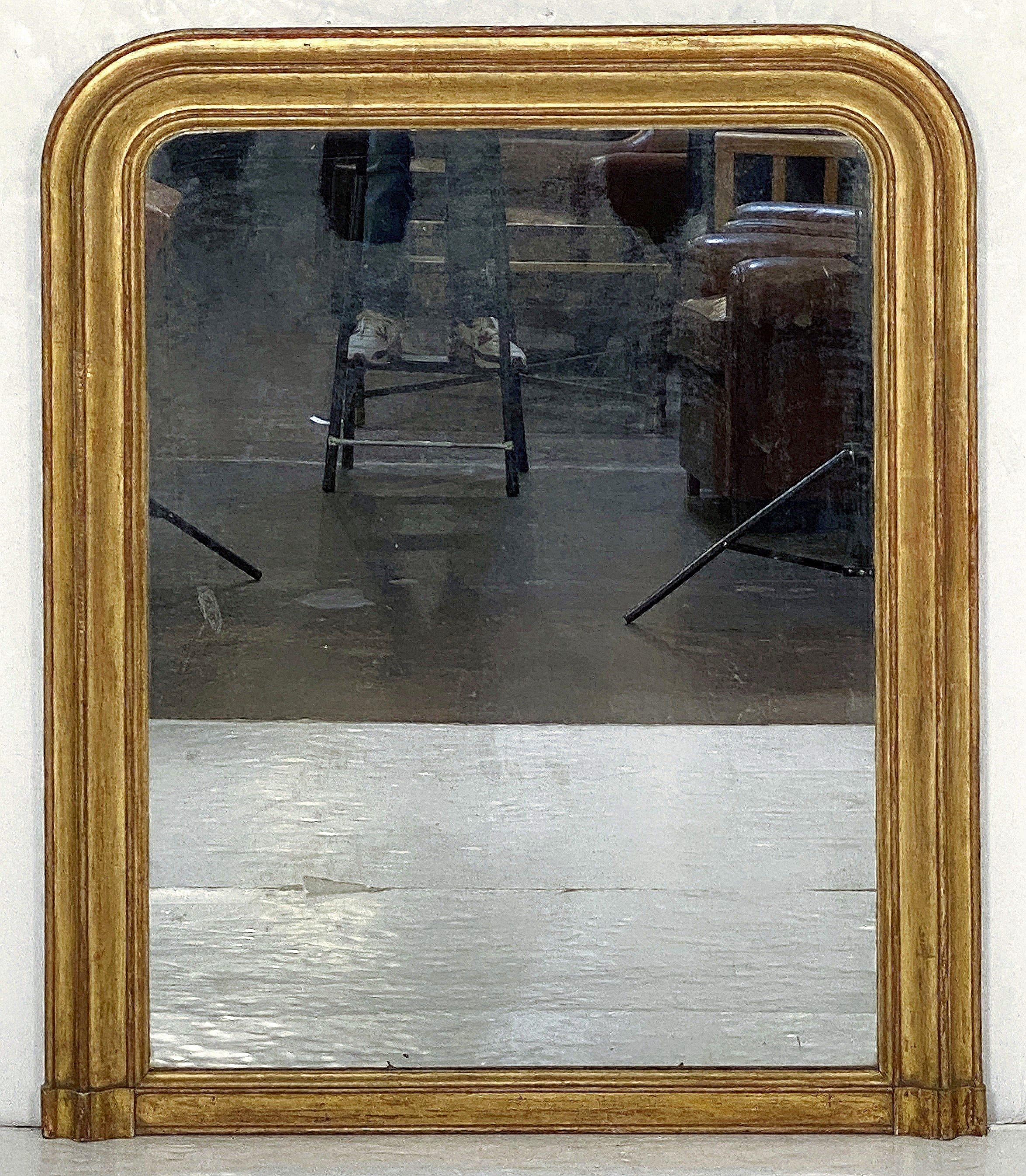 A fine large Louis Philippe gilt wall or hall or mantle mirror featuring a lovely moulded frame of patinated gold leaf. around the mirrored glass.

Dimensions: H 47 1/4 inches x W 39 inches

Other sizes also available in this style.