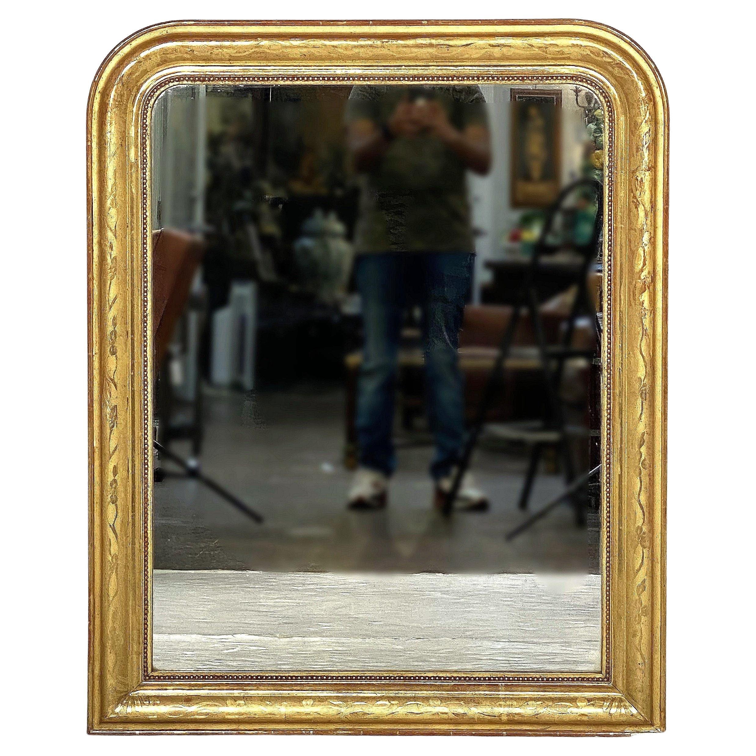 A fine large Louis Philippe arch top wall mirror from France, featuring a moulded surround with a beautiful patinated gold-leaf and etched foliate design.

Dimensions: H 42 3/4 inches x W 34 1/4 inches

Other sizes available in this style