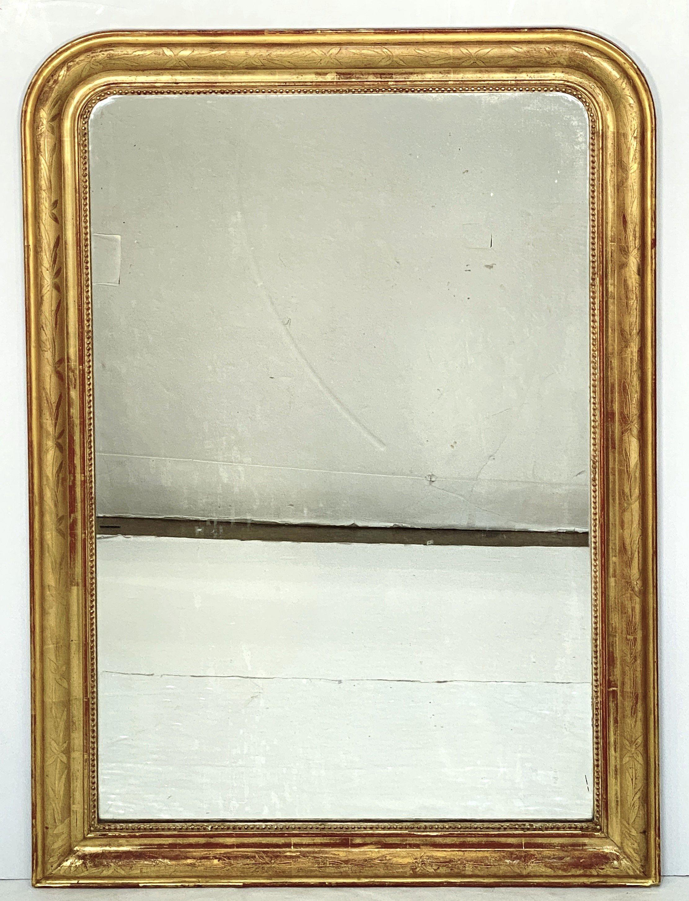 A fine large Louis Philippe arch top wall mirror from France, featuring a moulded surround with a beautiful patinated gold-leaf and etched foliate design.

Dimensions: H 49 1/4 inches x W 34 5/8 inches

Other sizes available in this style