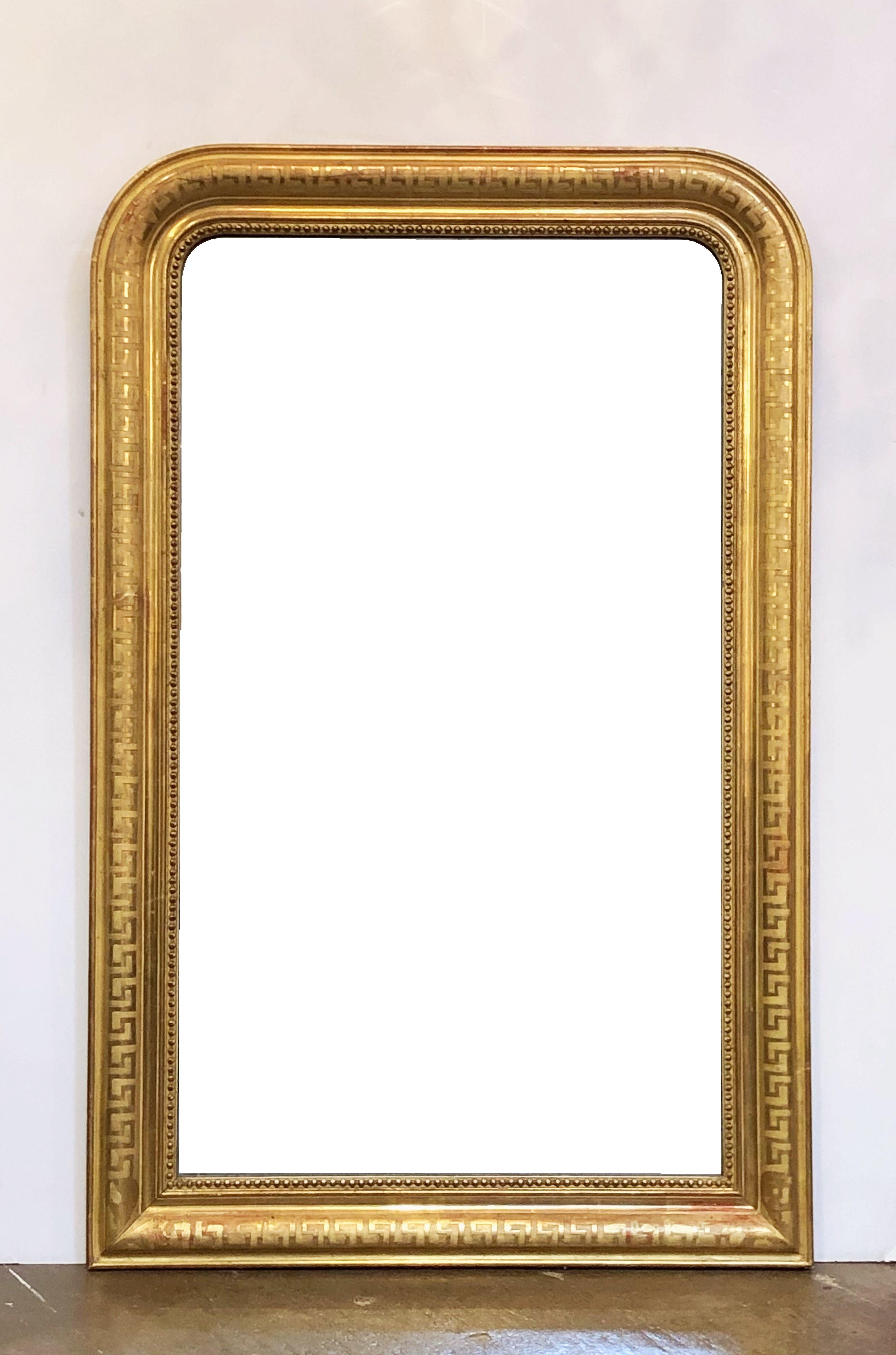A handsome large Louis Philippe gilt wall mirror from France, featuring a lovely moulded surround and an etched meander or 
