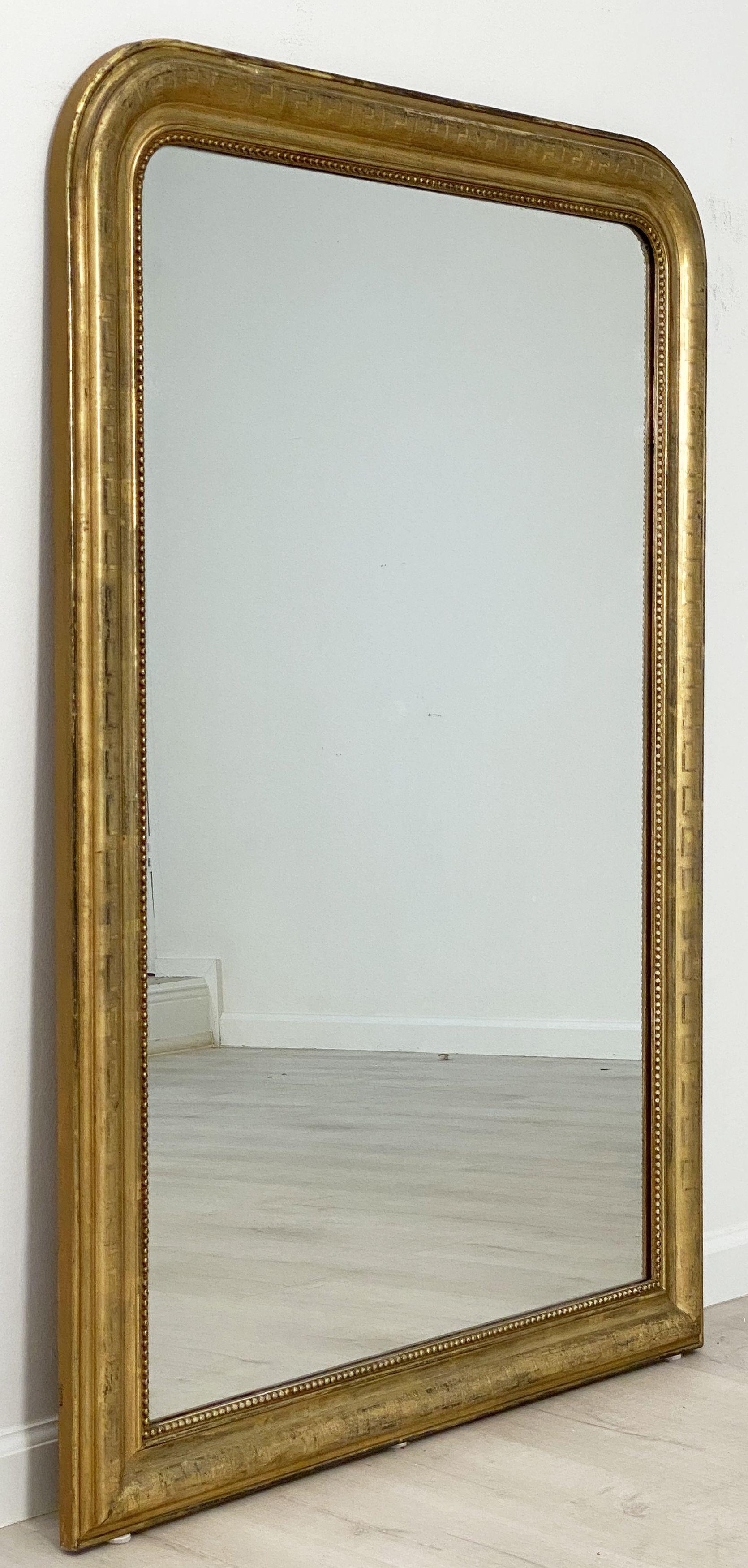 A handsome large Louis Philippe gilt wall mirror featuring a lovely moulded surround and an etched Greek Key design showing through gold-leaf.
With original mirrored glass in great condition.

Dimensions: H 54 inches x W 38 1/2 inches

Other