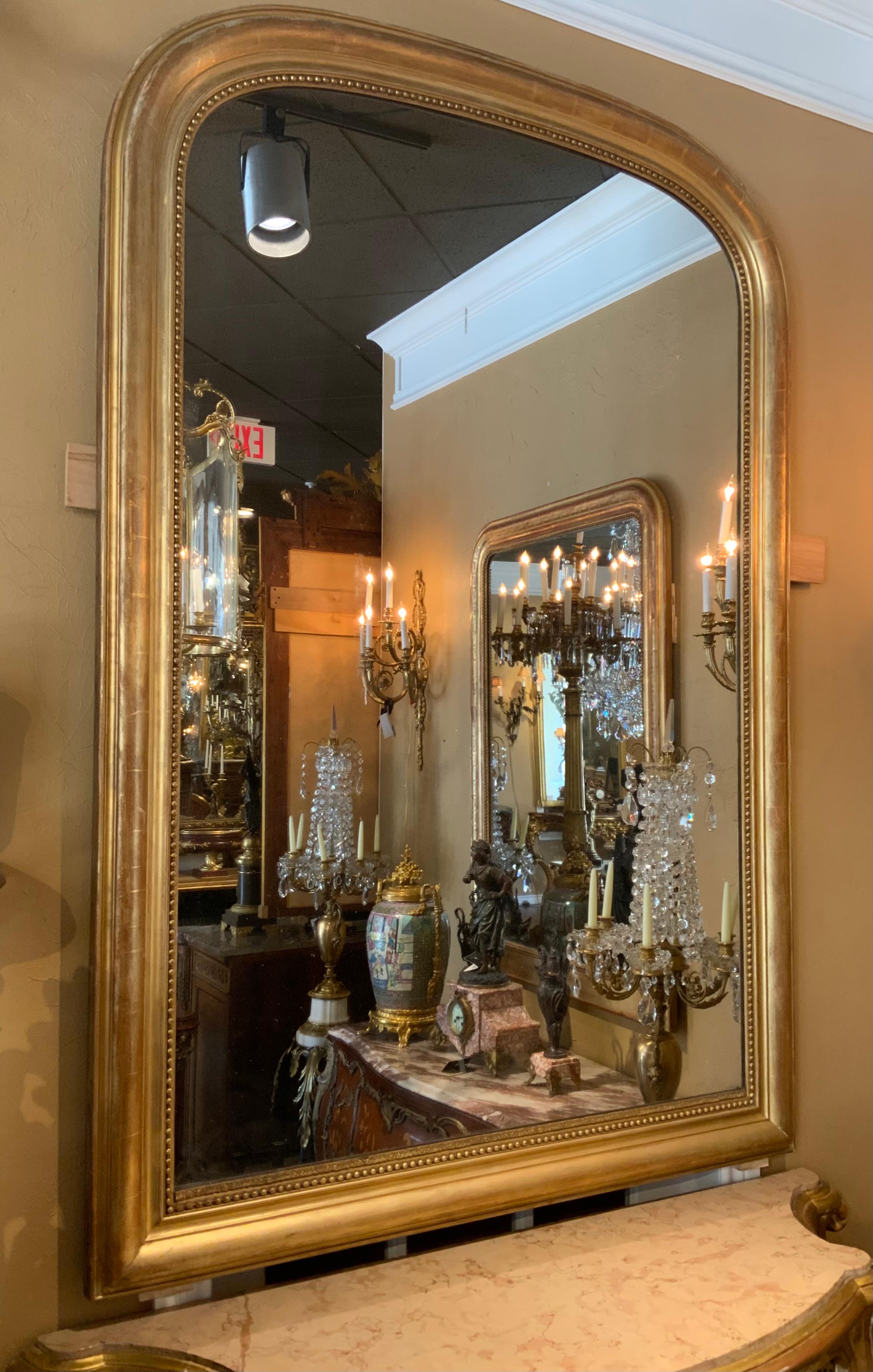 Espejo francés de madera dorada de la época Louis Philippe, con arco de
Marco con moldura de cuentas dorado original y placa de espejo original
