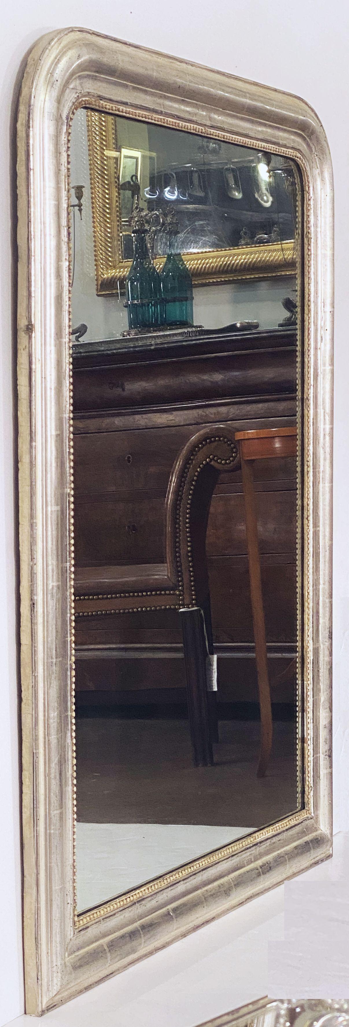 A fine tall Louis Philippe wall or dressing console mirror from France, featuring a moulded surround with a beautiful patinated silver-leaf.

Dimensions: H 47 1/4 inches x W 35 1/4 inches

Other sizes available in this style.

