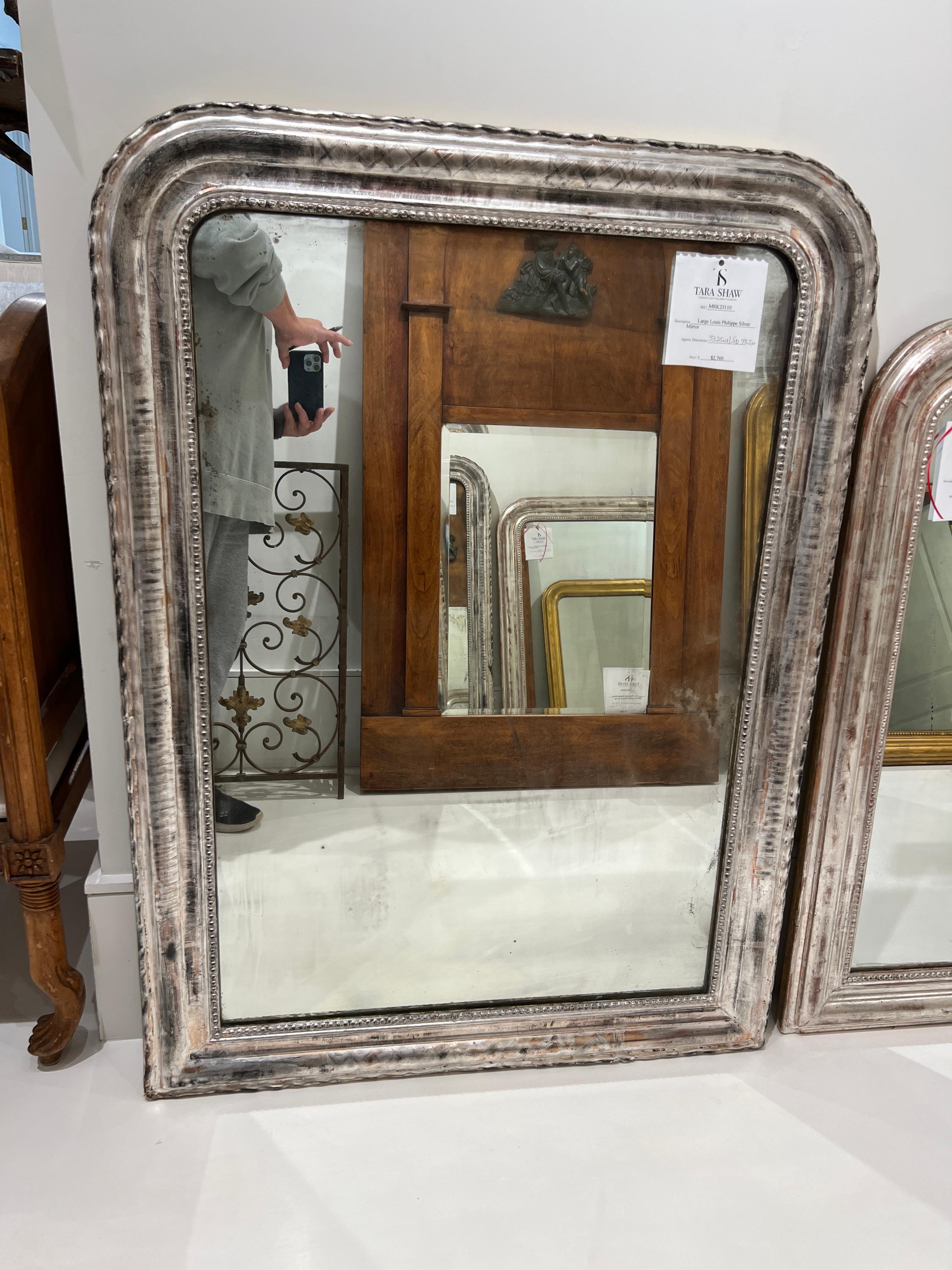 Large silver Louis Phillippe mirror with fine details.