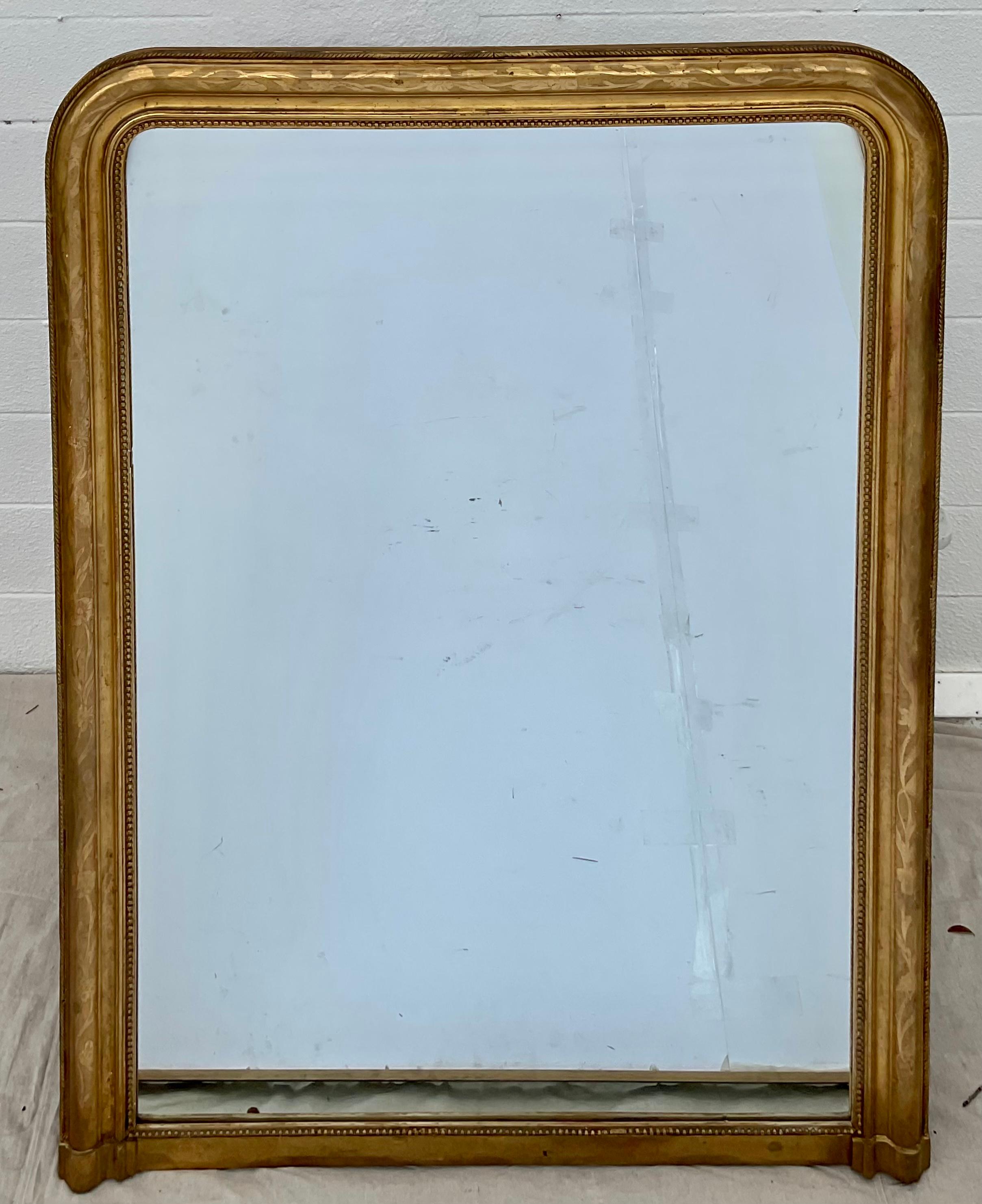 Louis Philippe mirrors are known for their rounded top corners and subtle embellishments to the frame. This fine large scale Classic example is surrounded by a lovely gilt frame.