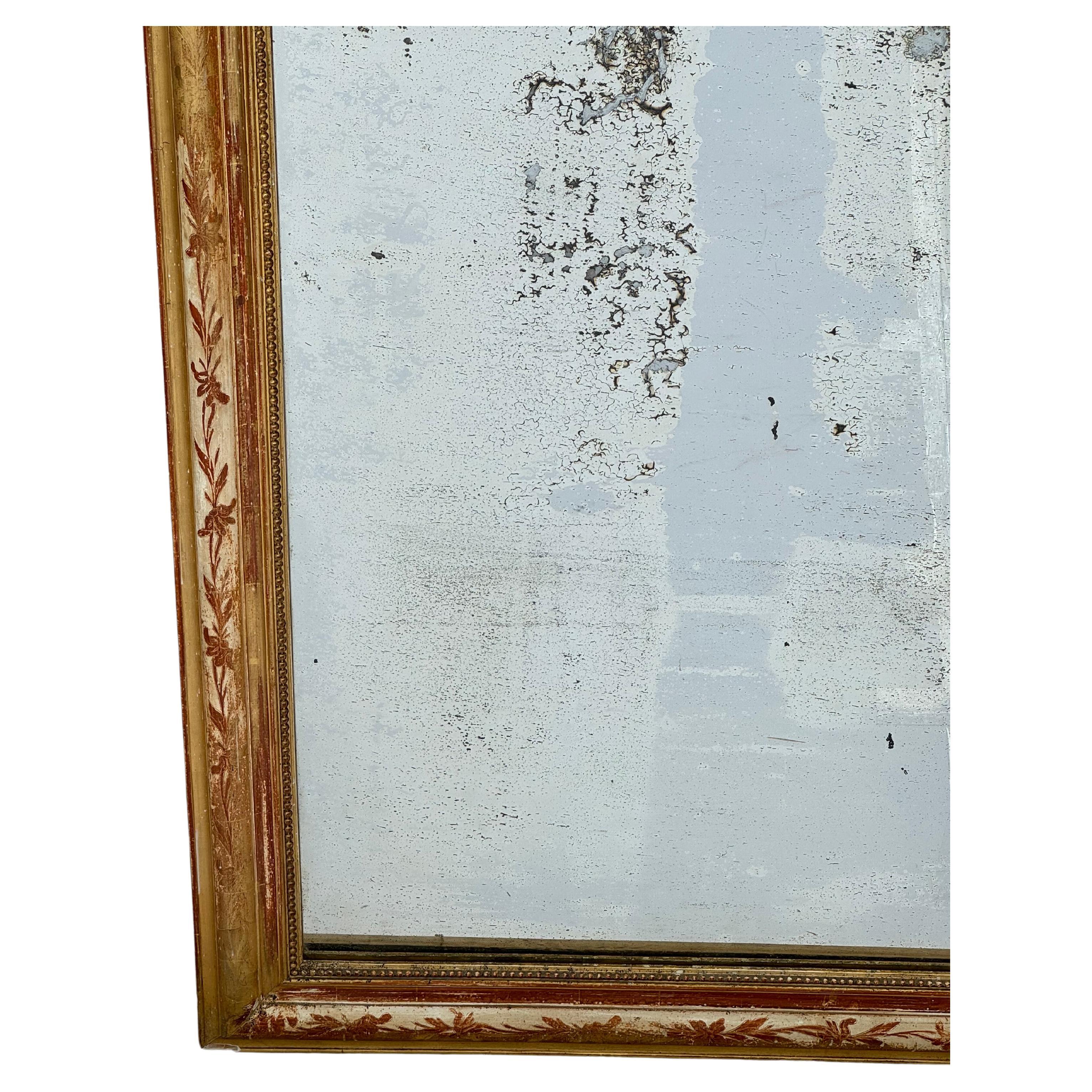 Louis Philippe mirrors are known for their rounded top corners and subtle embellishments to the frame. This fine large scale Classic example is surrounded by a lovely gilt frame. Frame has a lovely floral motif etched into the gilt.