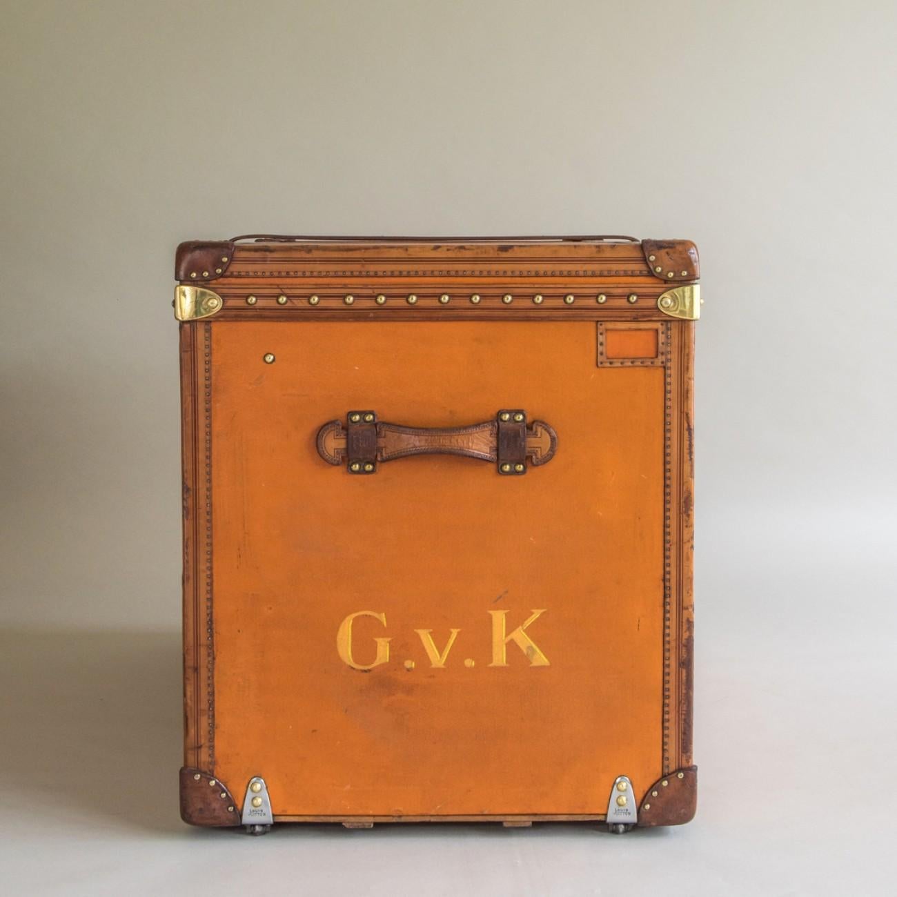 A splendid taller Louis Vuitton steamer trunk in orange Vuittonite (coated canvas) with leather trim to the edges, brass fittings, leather handles and original cotton lining to the interior. It even has the original leather strap around the middle