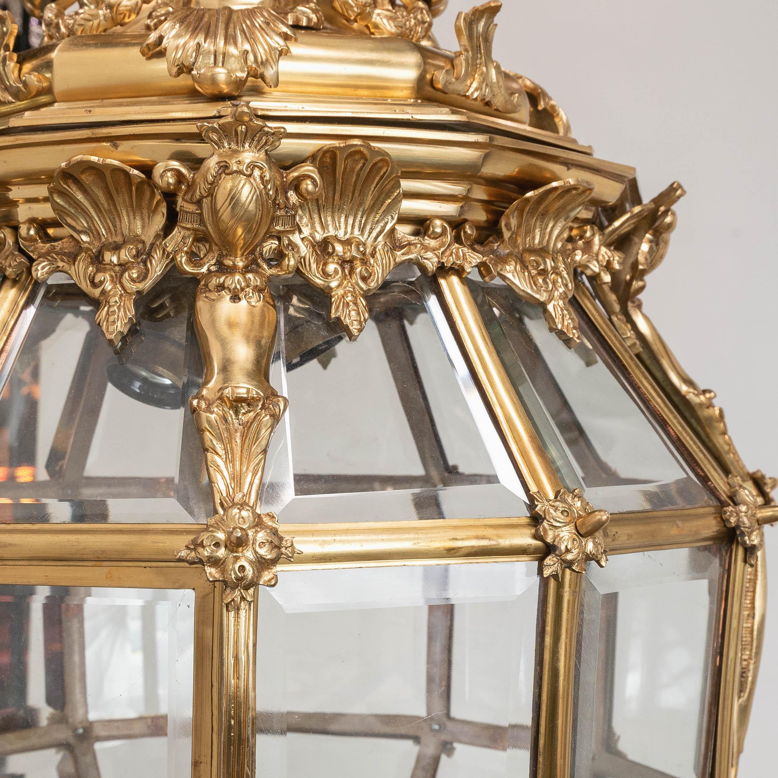 A very large Louis XIV style ‘Versailles’ lantern, a twentieth century model of the original created for the Château de Versailles, with three light fitment enclosed within bevelled glass glazed body. Re-wired and PAT tested.