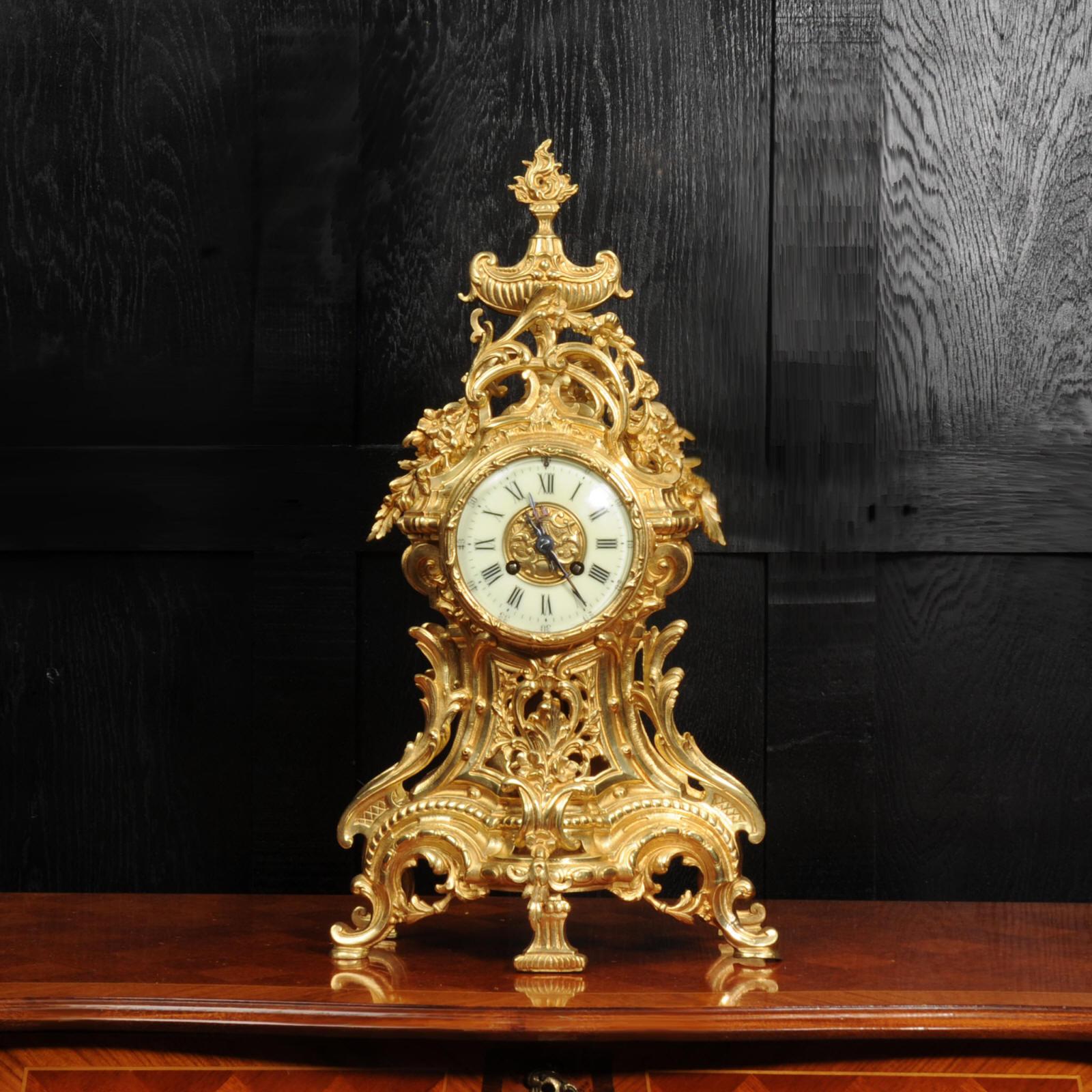 A large and impressive original antique French clock by Louis Japy. It is beautifully made in gilded bronze in the Louis XV style. Waisted case with a fretted front to allow a glimpse of the pendulum gently swinging inside. Profusely decorated with