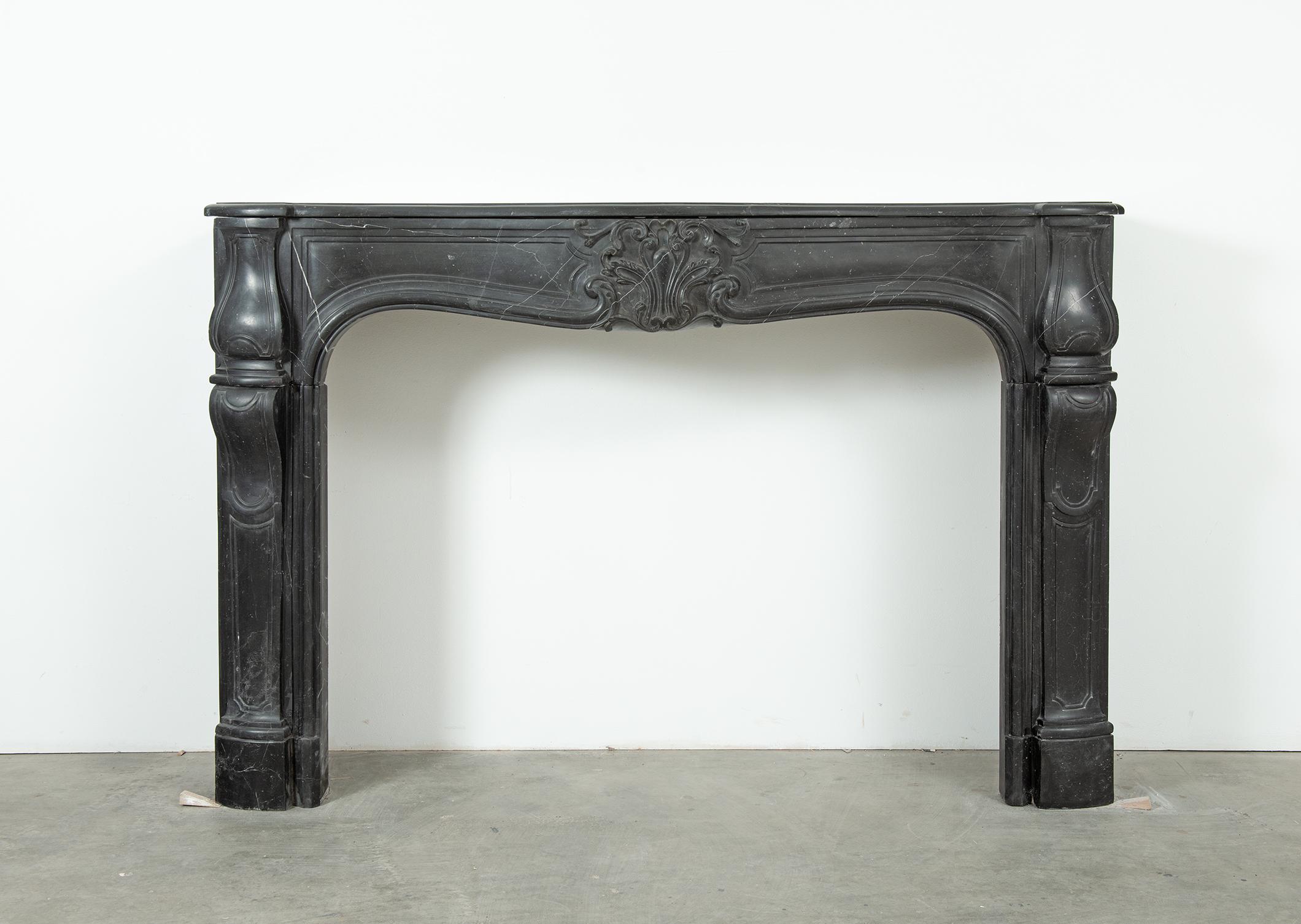 Large Louis XV Fireplace Mantel in Rare Noir de Sable Marble – 18th Century Elegance

This exceptional Louis XV fireplace mantel is carved from the rare and luxurious Noir de Sable marble, known for its deep black hue highlighted with subtle white