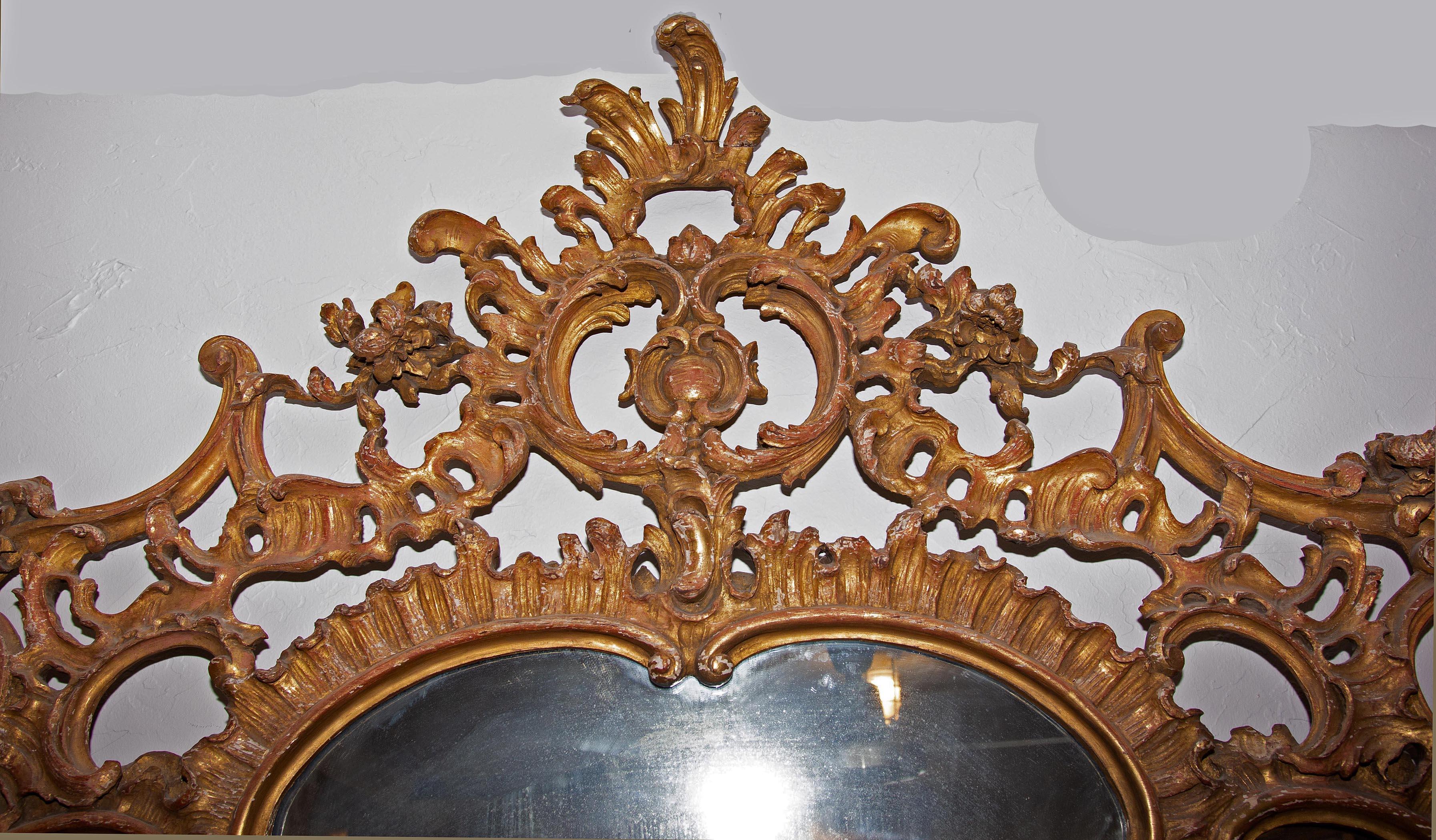 Large antique continental carved and gold gilt over mantel (fireplace) mirror, 19th century. Measures: 60