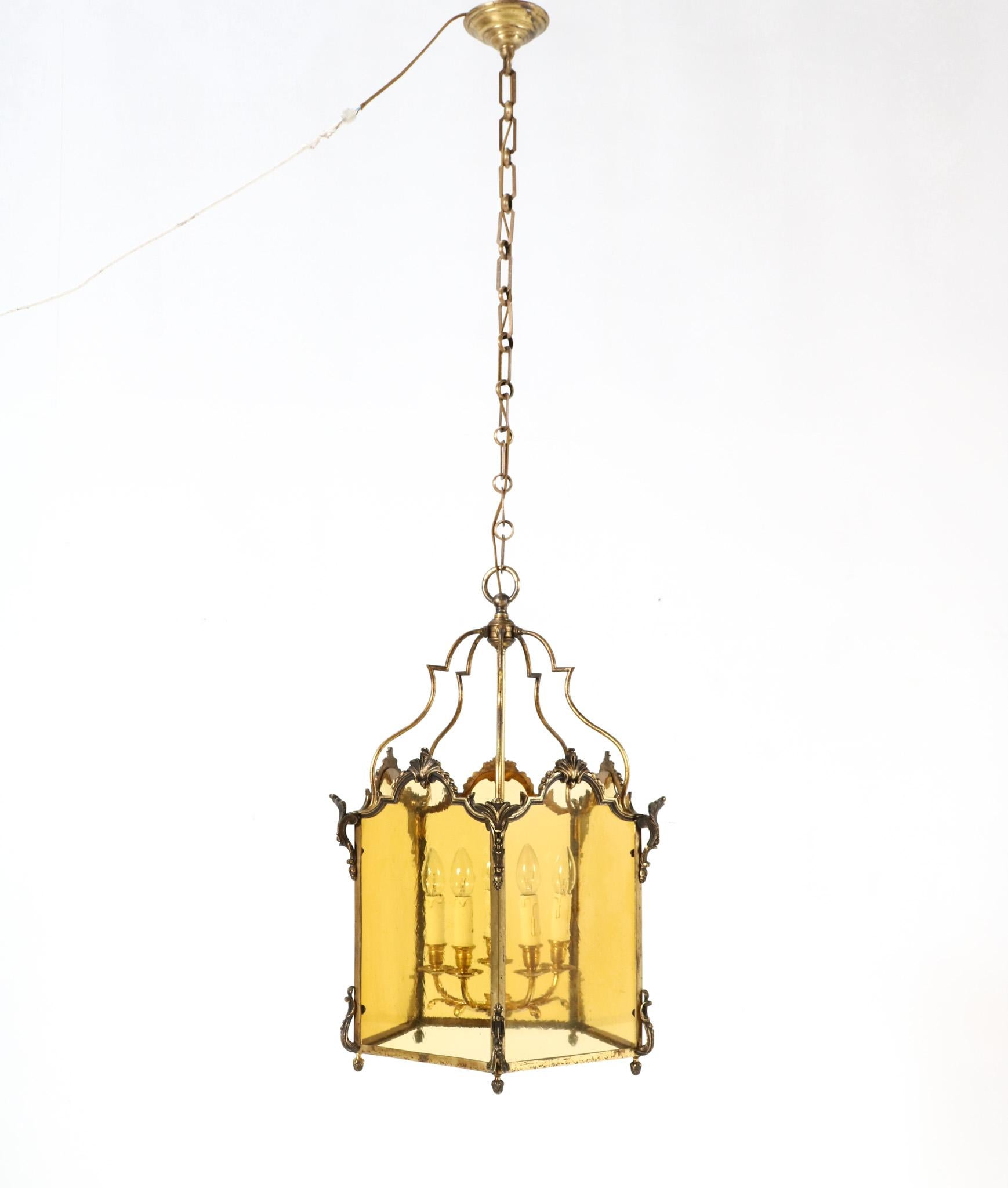 Magnificent and elegant 19th Century Louis XV style hall lantern.
Striking French design from the 1870s.
Original gilt bronze doré shell-crested frame with five original yellow colored hand-blown glass panels.
Originally for candles, this hall