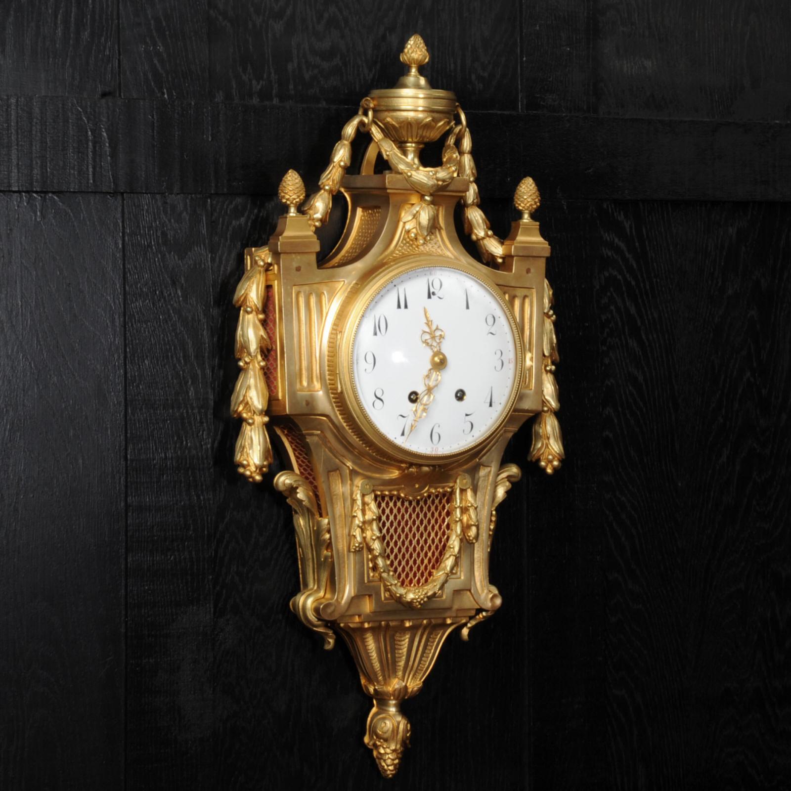 A large and stunning original antique French Cartel wall clock by Vincenti et Cie, circa 1870. It is Louis XVI in style, classical case with pineapple finials, a large urn and draped with a large acanthus swag. Beautifully made in gilt bronze. The