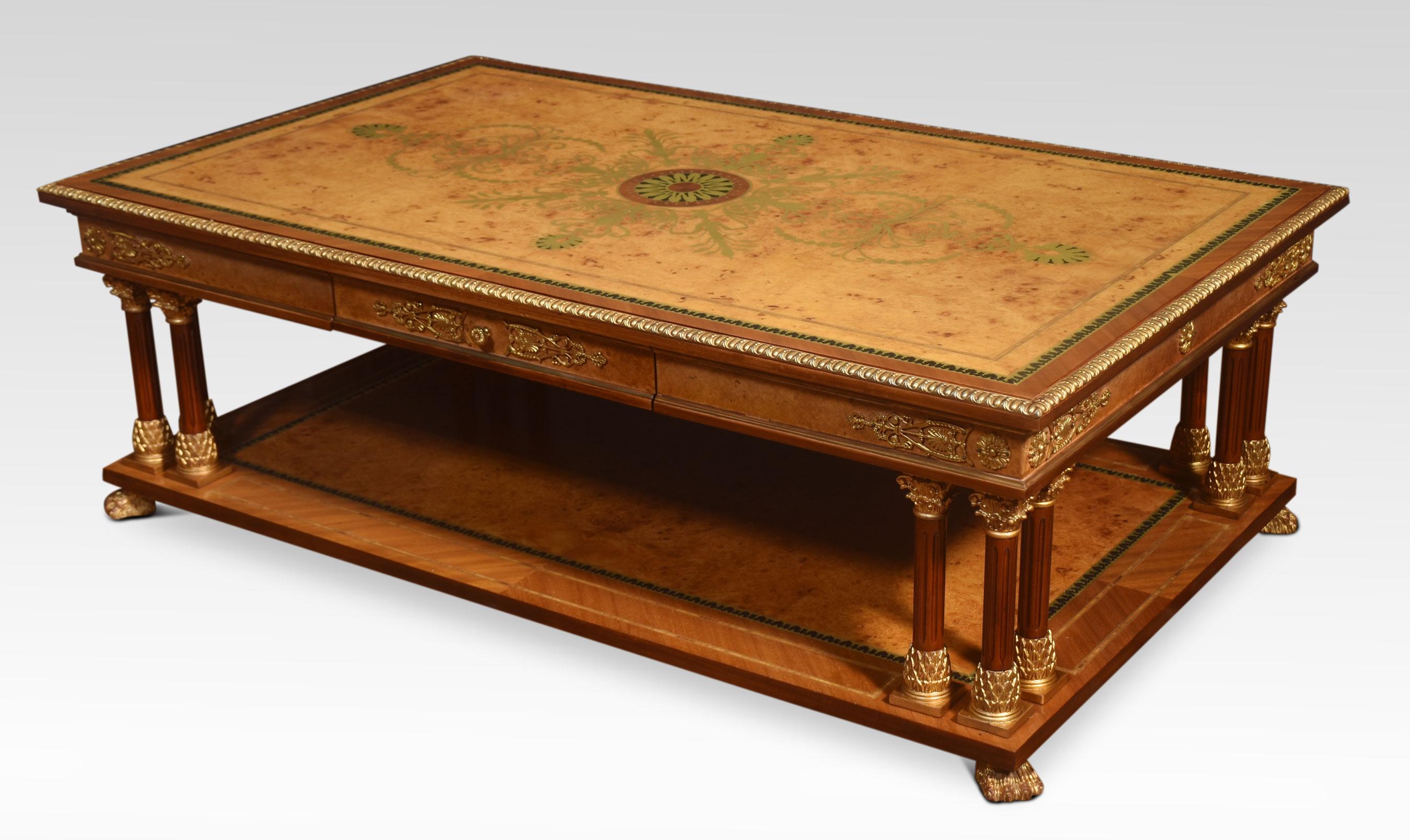 Large Louis XVI style coffee table, the anthemion brass inlaid rectangular top having ebonised border and tooled edge. To the frieze fitted with a long drawer. Raised on column legs, gilt metal mounts throughout. Terminating in hairy lion paw