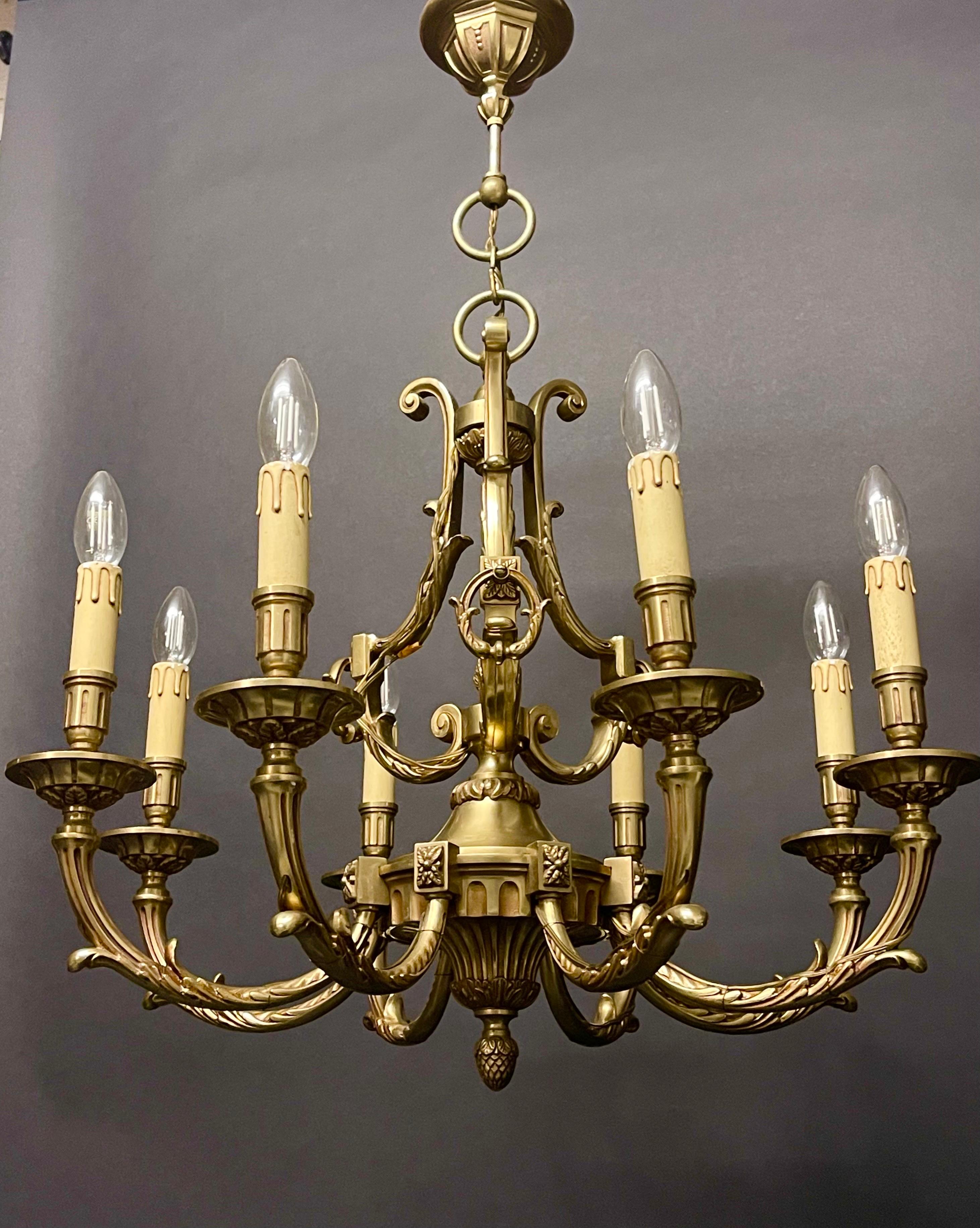 A beautiful solid bronze chandelier attr. to (Maison Lucien Gau), Paris, France.
The chandelier has eight scroll arms and displays great elegance, thanks to a platinum coating old gold. This chandelier is inspired by the mid-18th century and in the