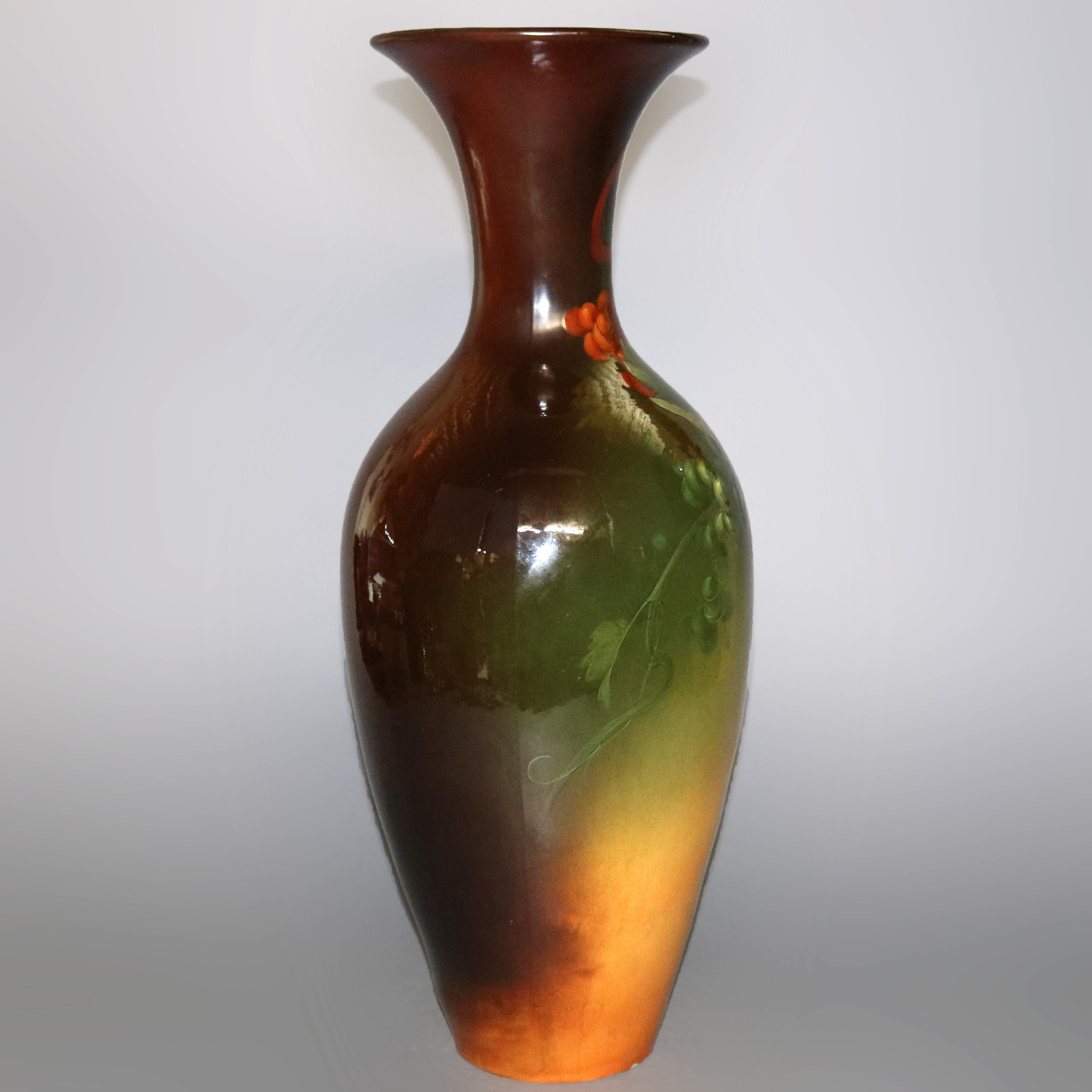 Large antique Arts & Crafts art pottery floor vase by Louwelsa Weller offers grape and vine decoration with standard glaze, maker mark stamped in base as photographed, circa 1910

Measures: 25