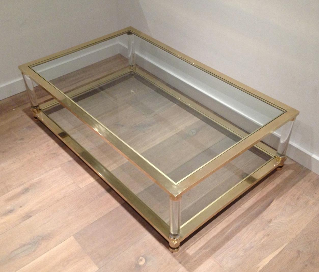 This very nice and large coffee table is made of brass with round lucite legs .The quality of this table is really nice. This is a French work. Circa 1970