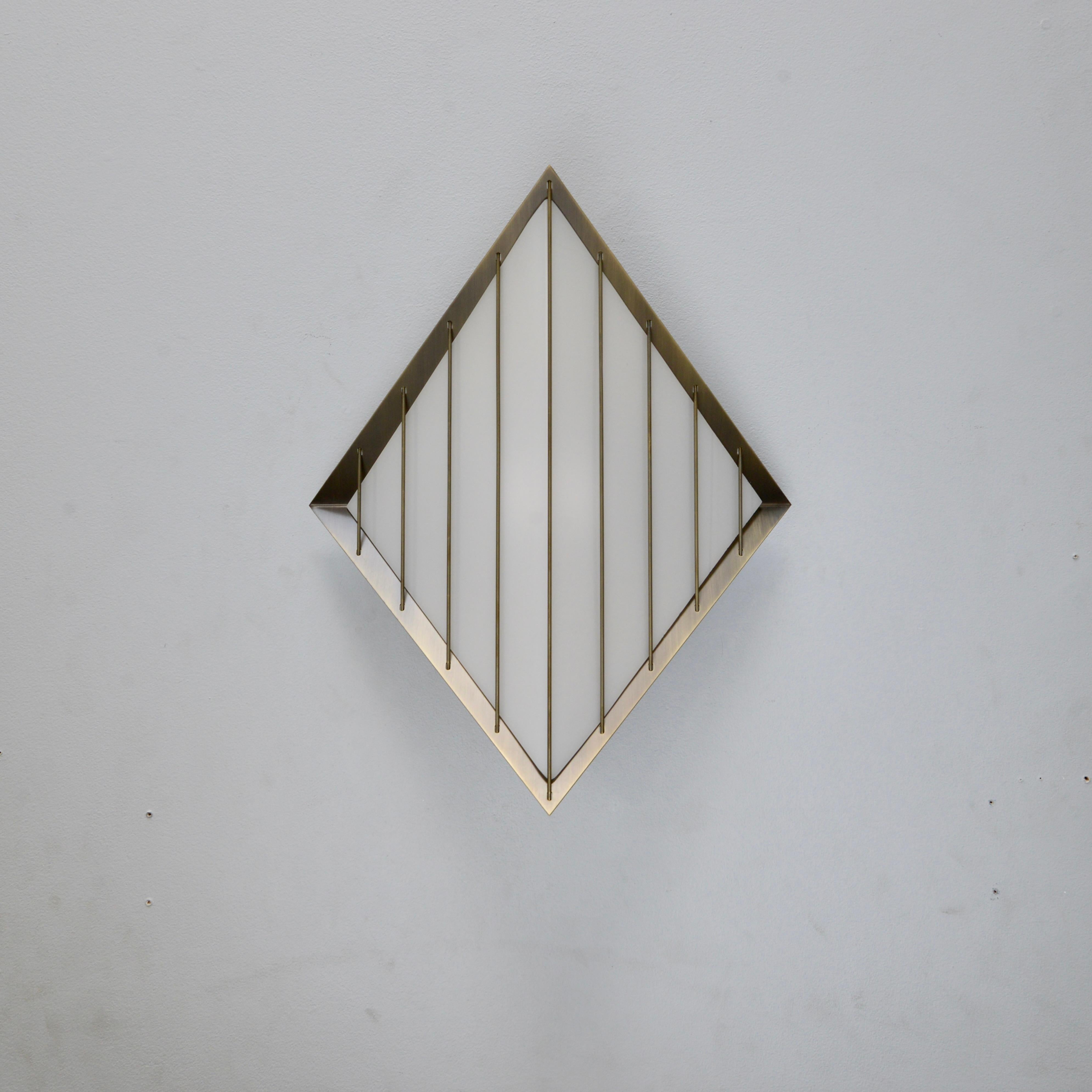 The Large LUdimanti Indoor Outdoor Sconce is part of Lumfardo Luminaires contemporary lighting collection and a larger interpretation of the LUdimanti I/O Sconce.
This diamond shaped brass and acrylic sconce is made to order and can be used either