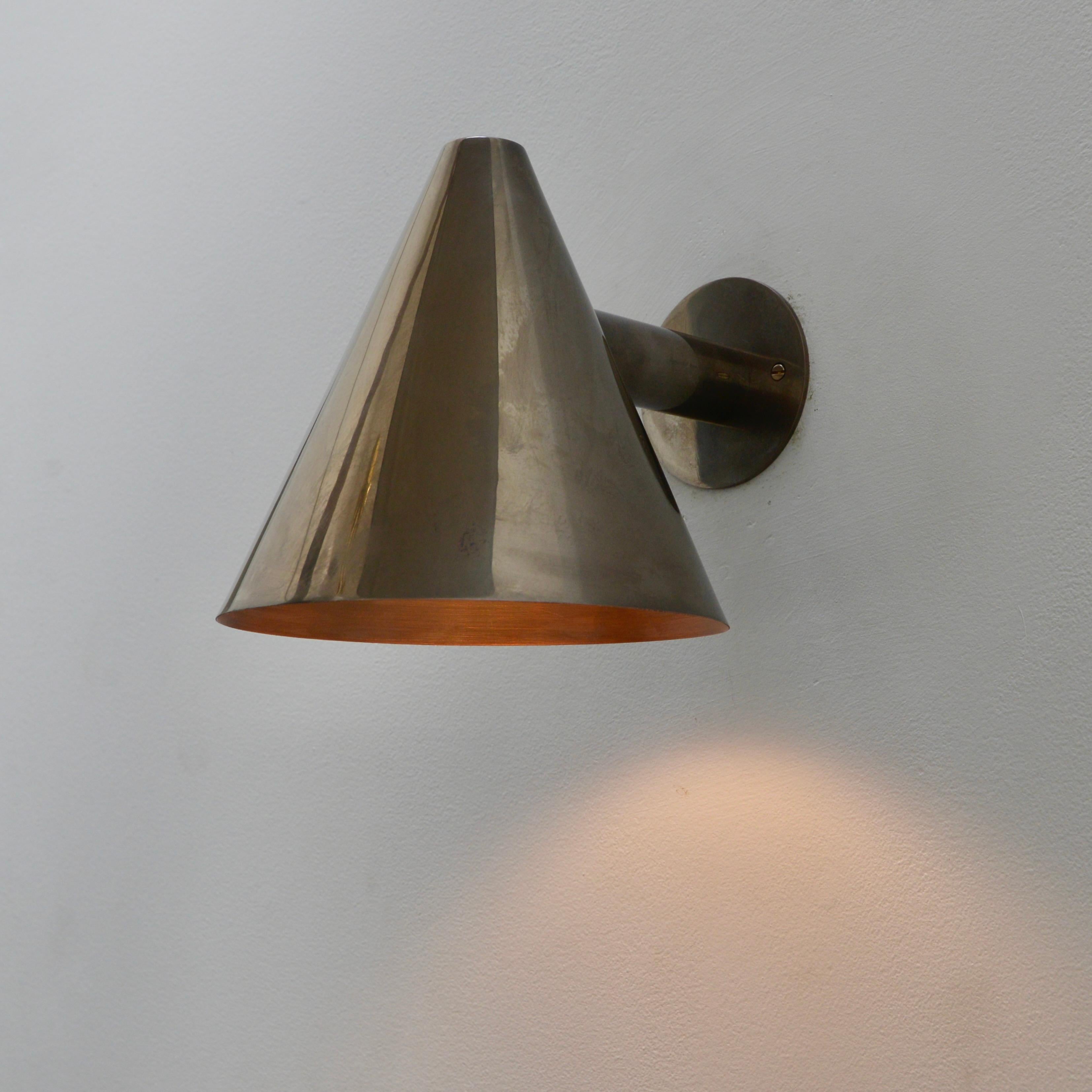 Part of our Lumfardo Luminaries contemporary collection, this larger version LUhans patinated un-lacquered copper indoor outdoor sconce is inspired by Scandinavian mid-century design. Wired with a single E26 socket for use in the US. Can be wired