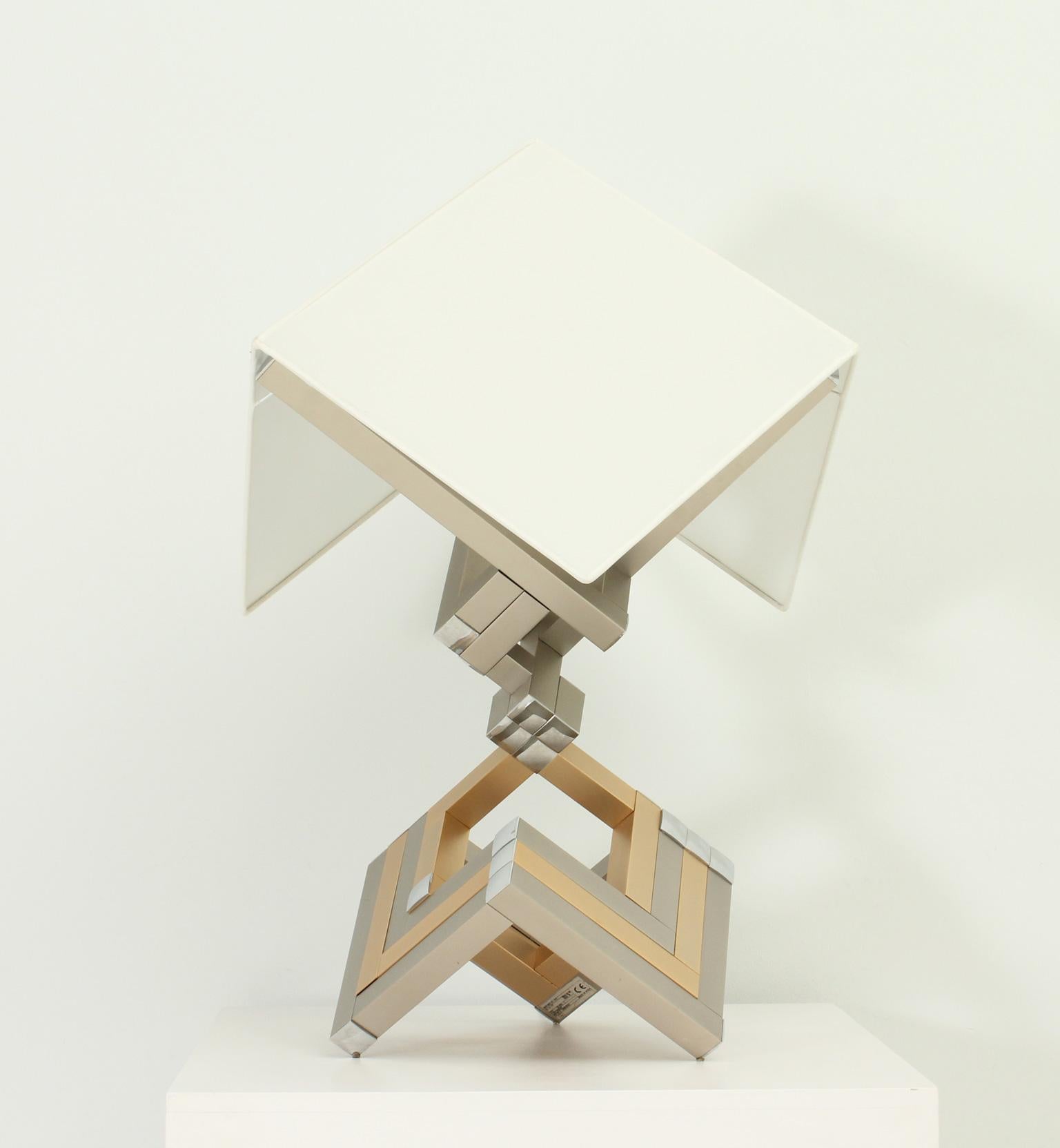 Rare table lamp designed in 1970's by Lumica, Spain. Chrome, brass and polished steel structure supporting three bulbs and a square shade with new fabric.