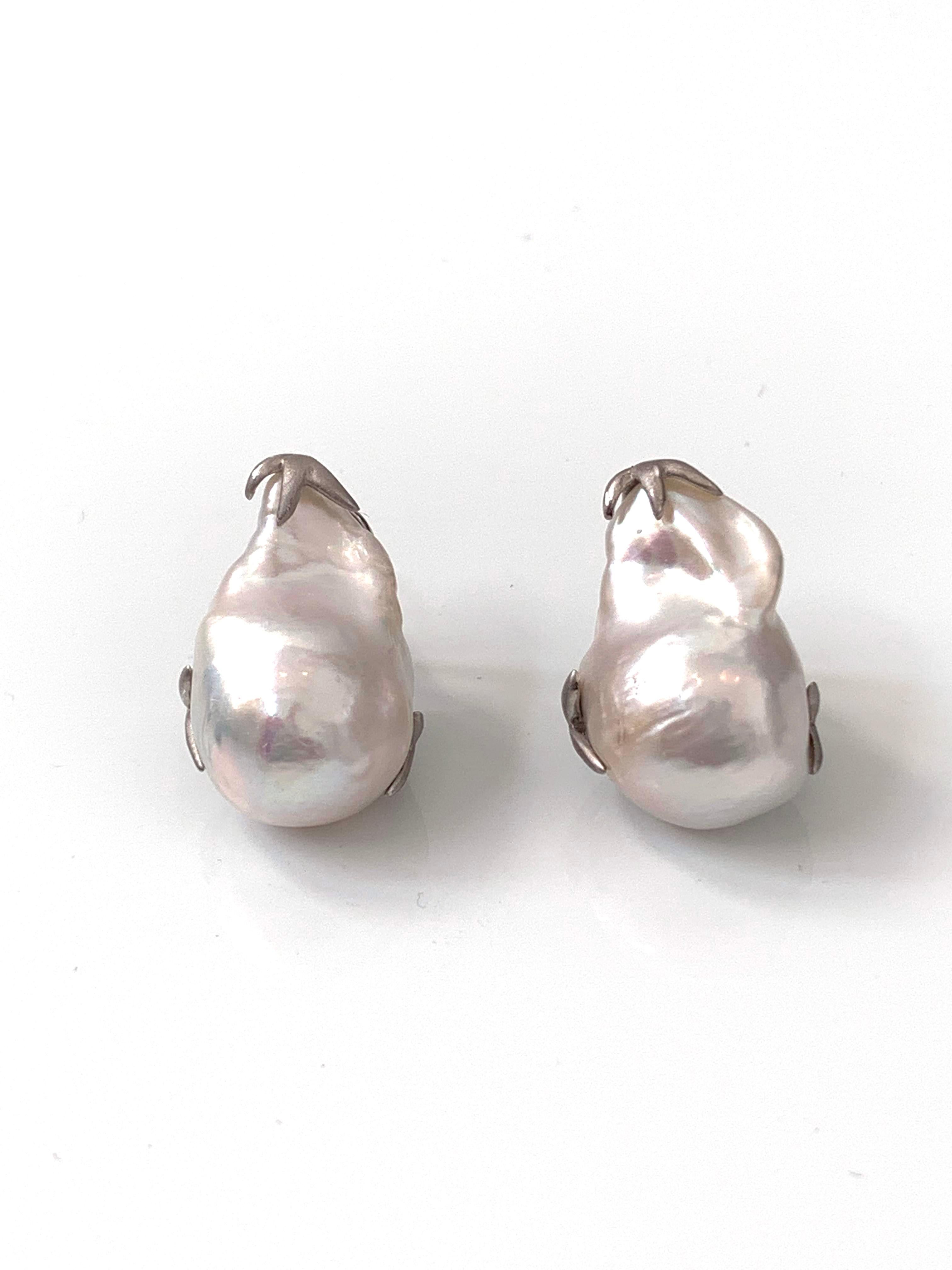 Beautiful pair of large lustrous freshwater baroque pearl earrings. The pair measures 15mm width and 23mm height, handset in platinum-plated sterling silver (matte finish). Post-clip backs provide addition support (Very comfortable). 

Each pair is