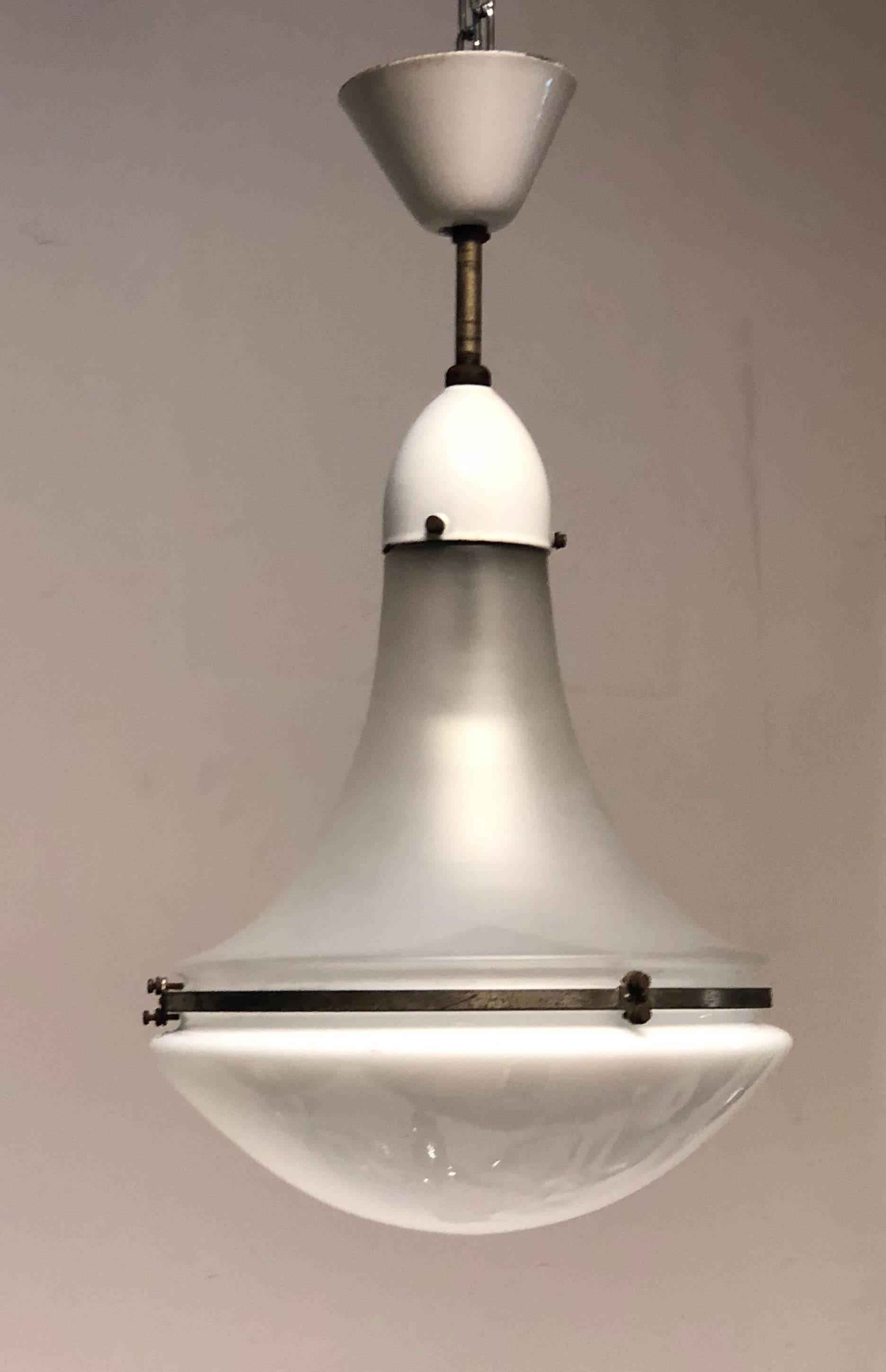 Steel with white enamel, fitted with one E27 porcelain socket up to 100W. Upper shade clear glass satin finish, lower part opaline glass. Originally designed by Peter Behrens for AEG this one was made in the 1930s.
Measure: It is the bigger one